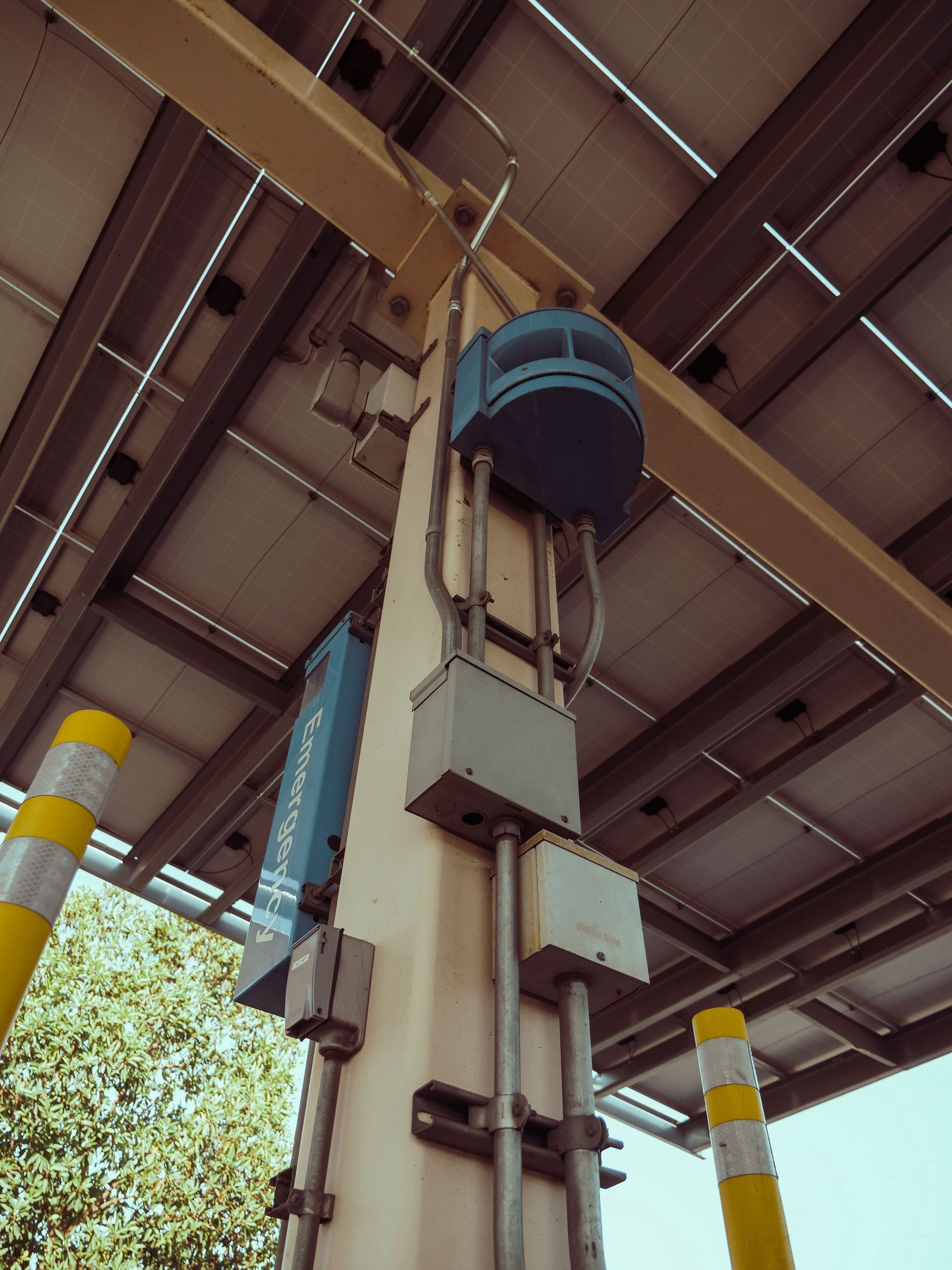 Under-bridge view of a large industrial lift structure with blue machinery and metal beams