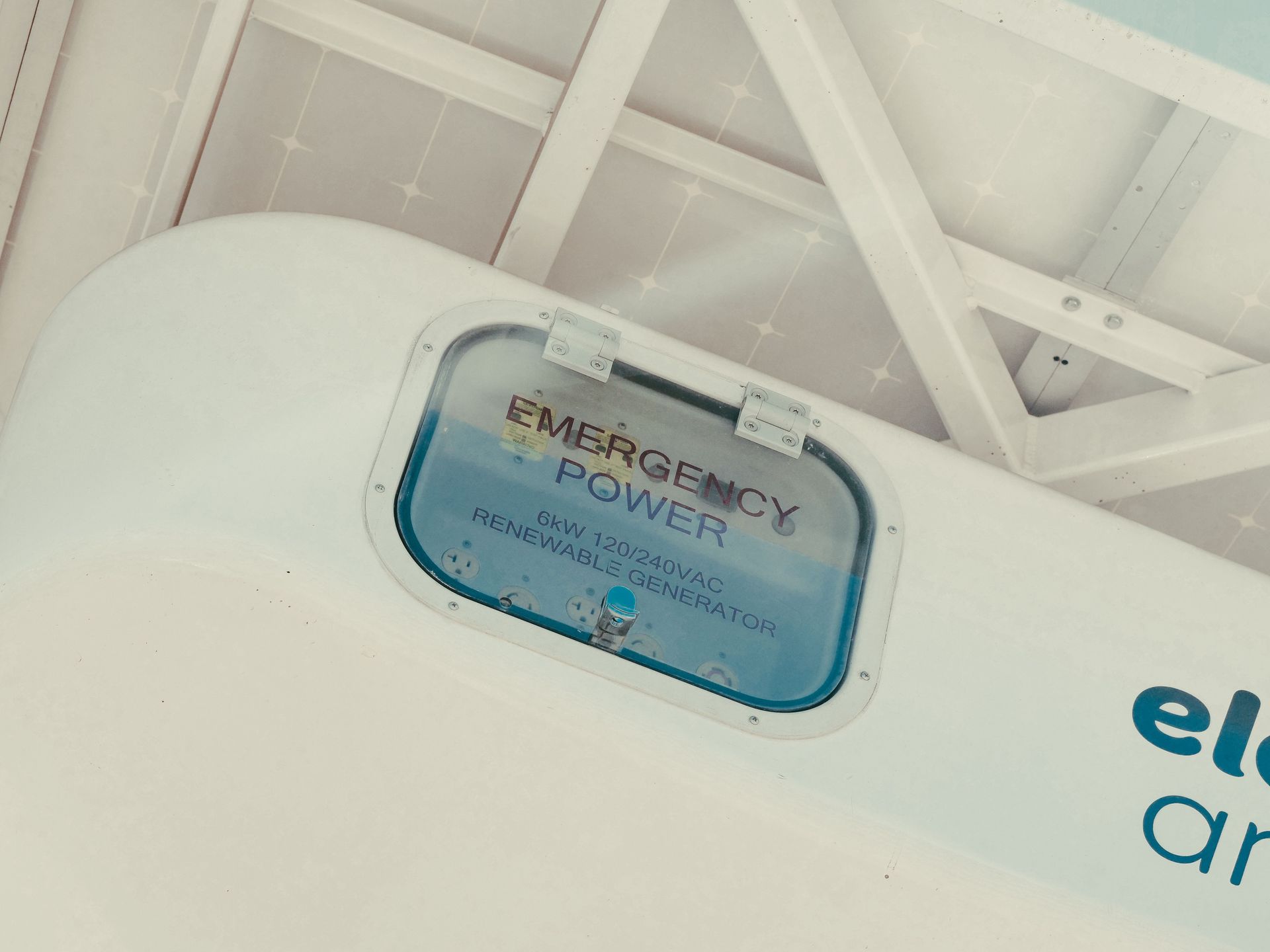 Emergency power sign on a white ceiling panel with blue trim