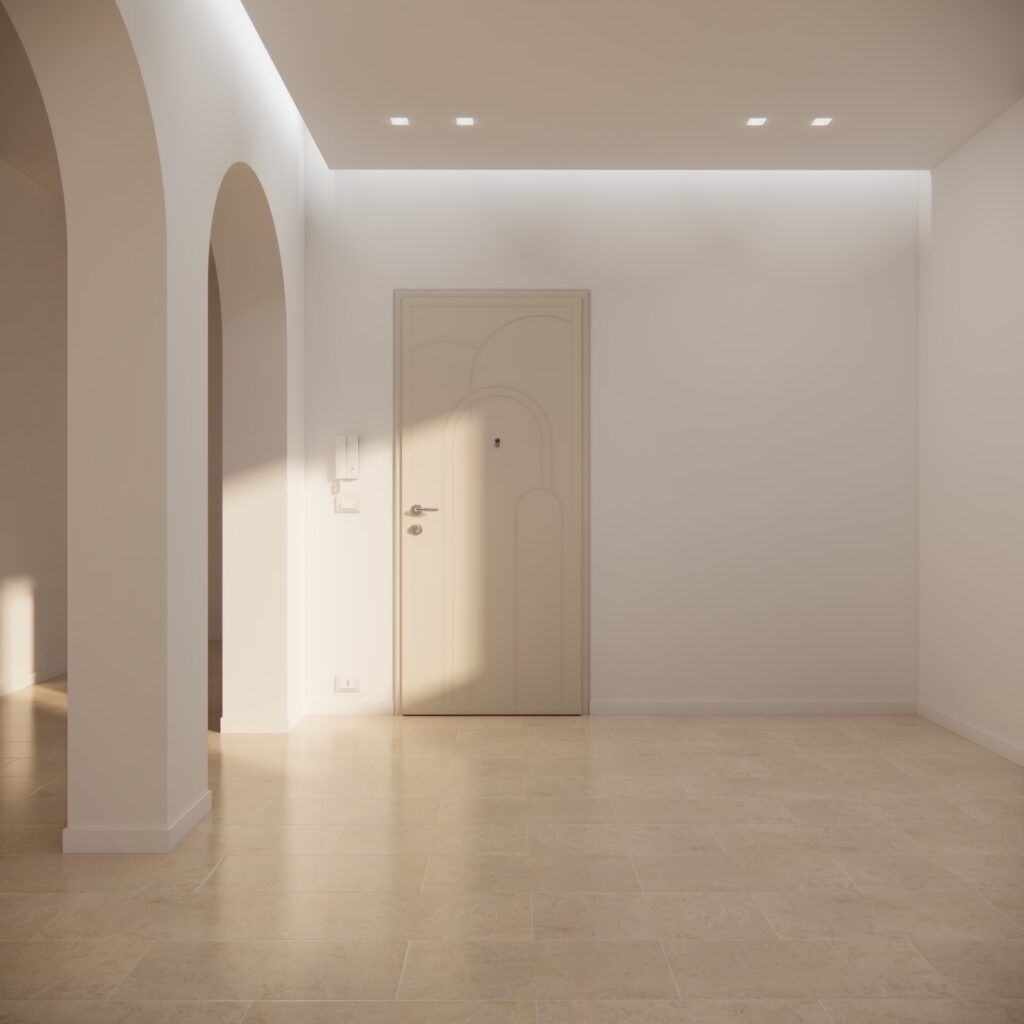 Stanza minimalista vuota con pareti beige, una porta ad arco e una porta color crema chiusa, illuminata dalla luce del sole