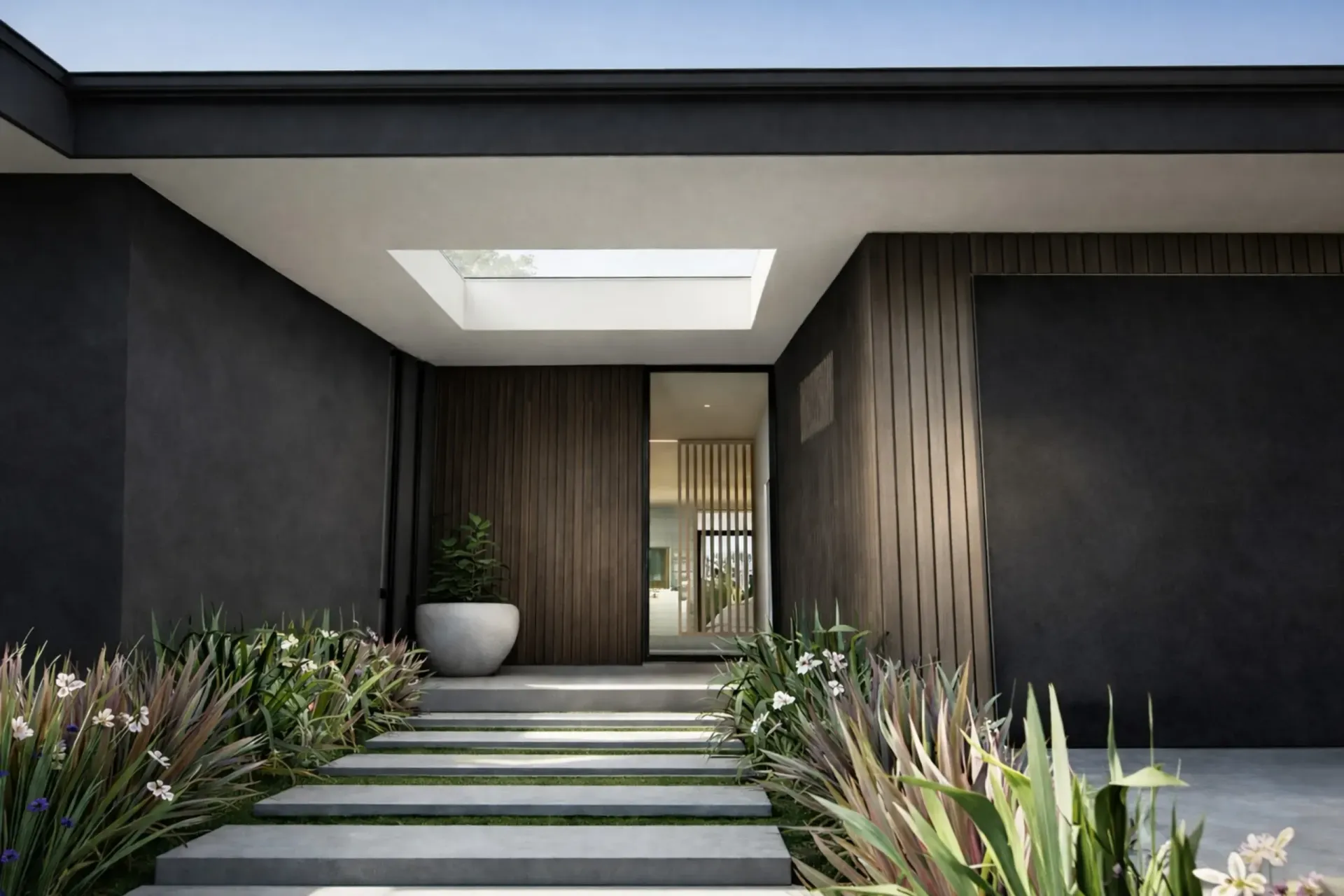 Outdoor living space with a sofa, patio, dark wood paneling, and a white tiled wall.