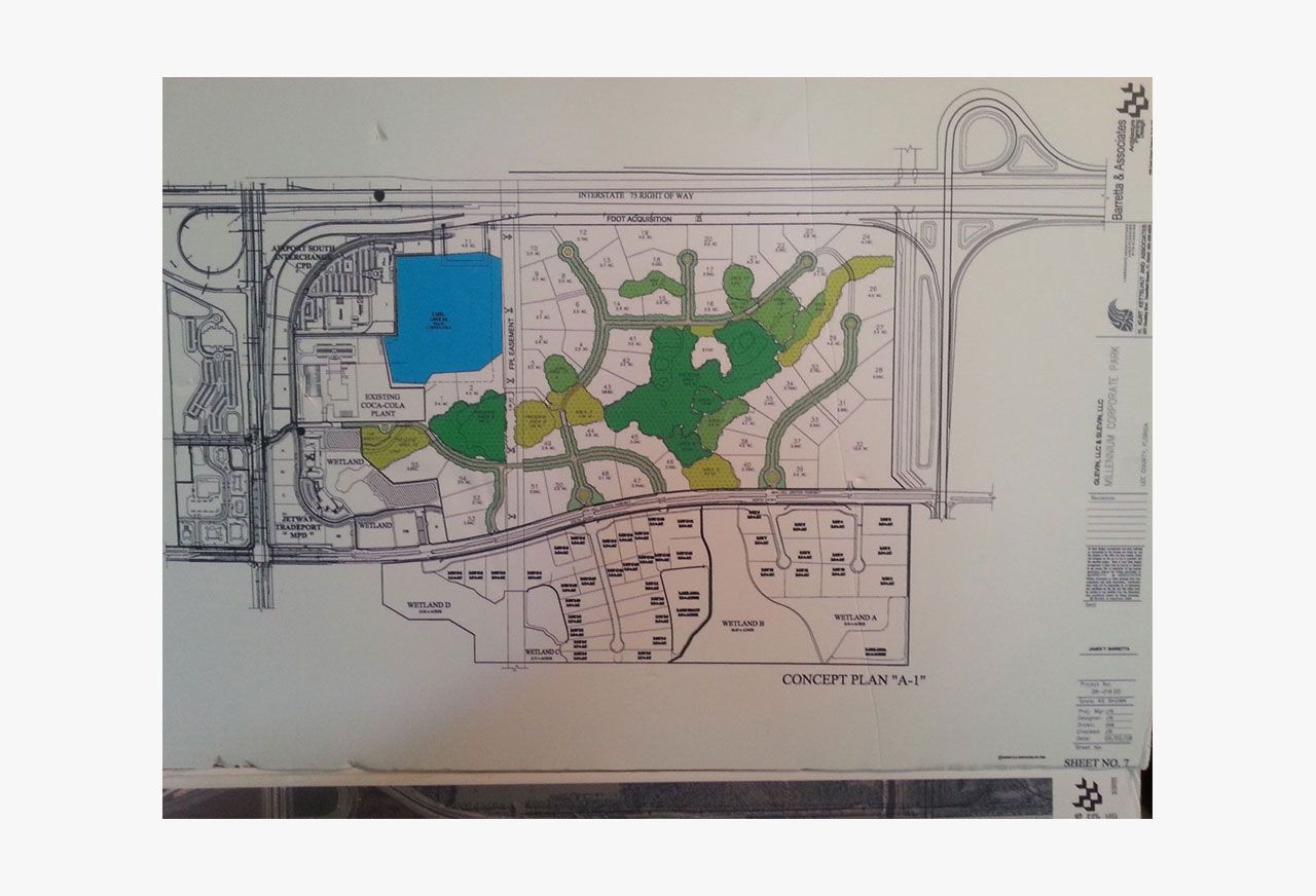 A map of a park layout with roads, a lake, green spaces, and buildings; various colors.
