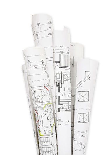 a bunch of blueprints are stacked on top of each other on a white background .