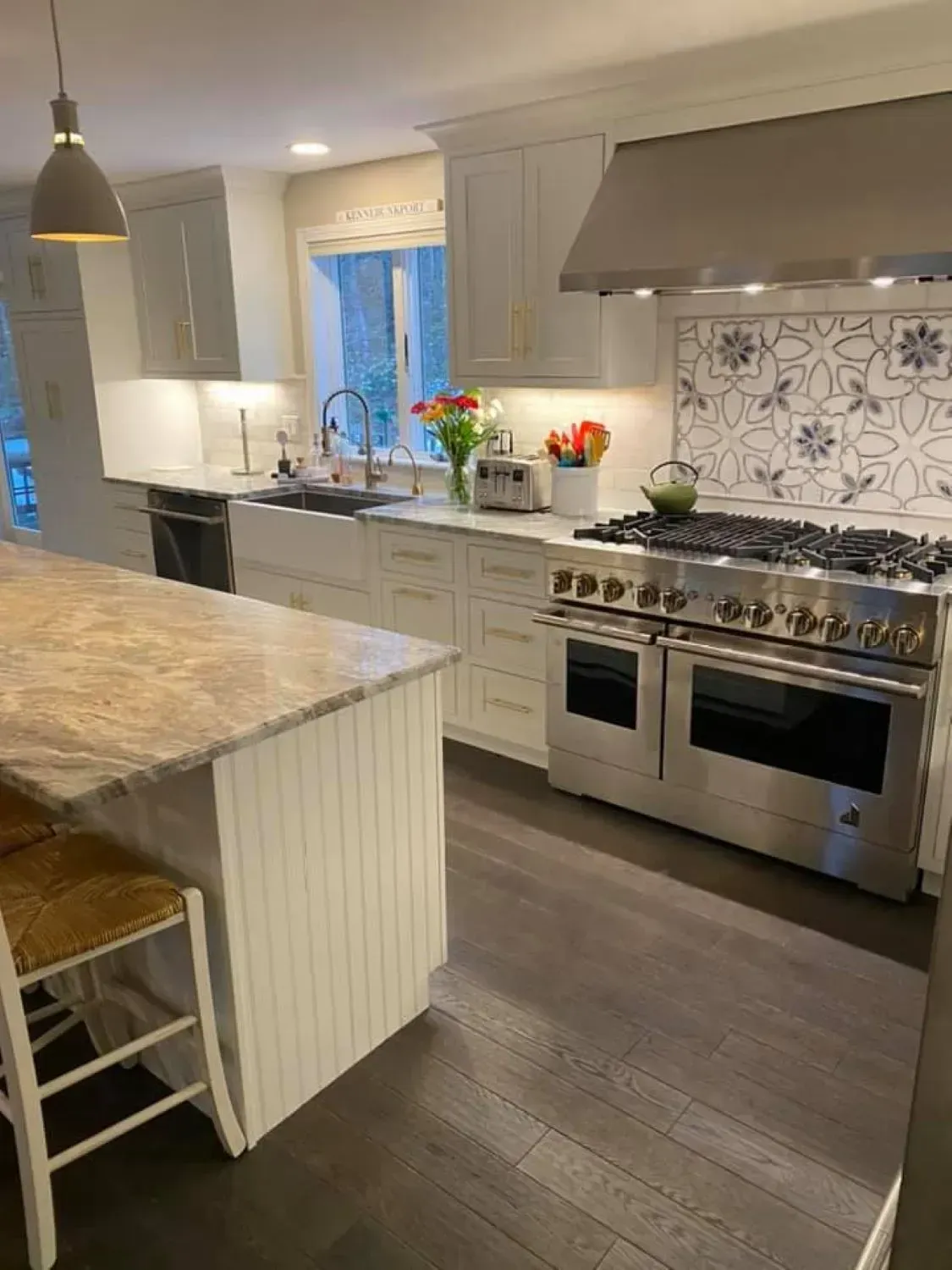 A kitchen with stainless steel appliances and a large island.
