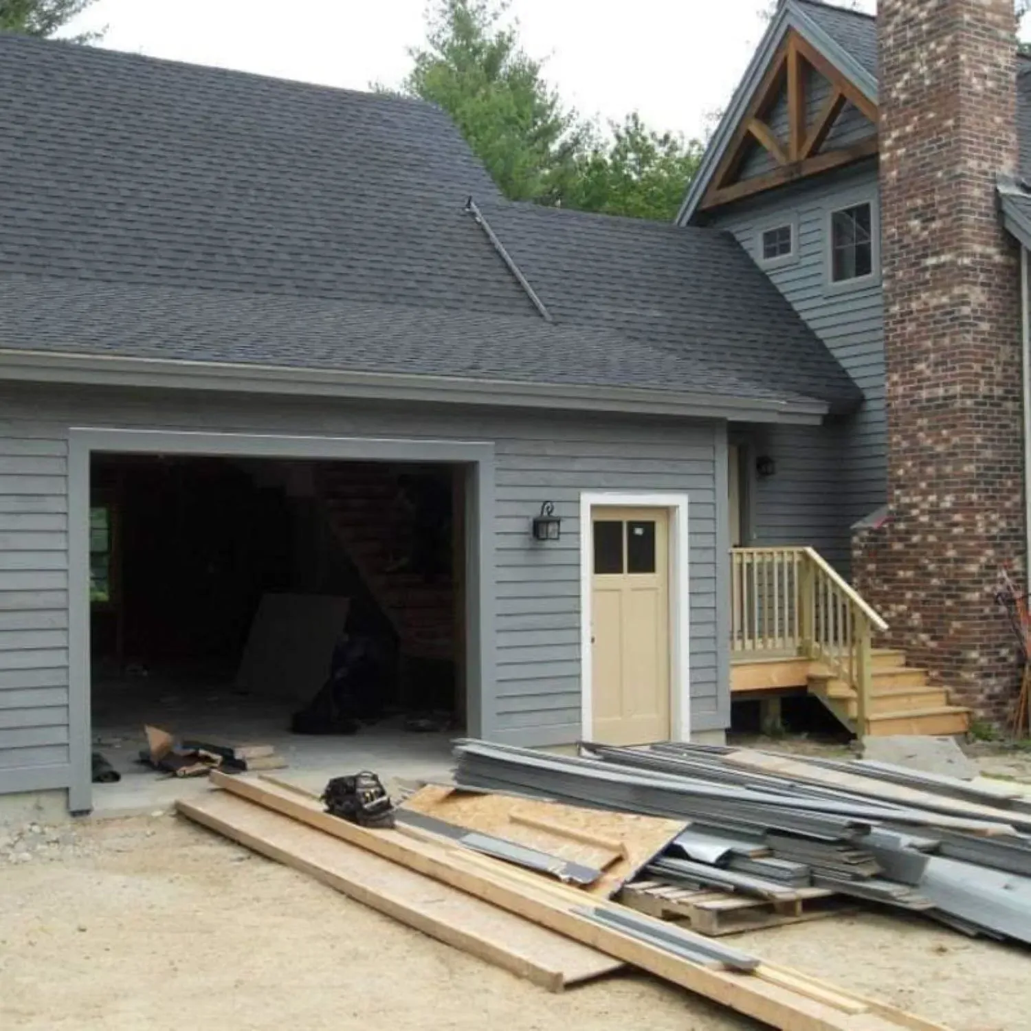 A house under construction with a garage door open