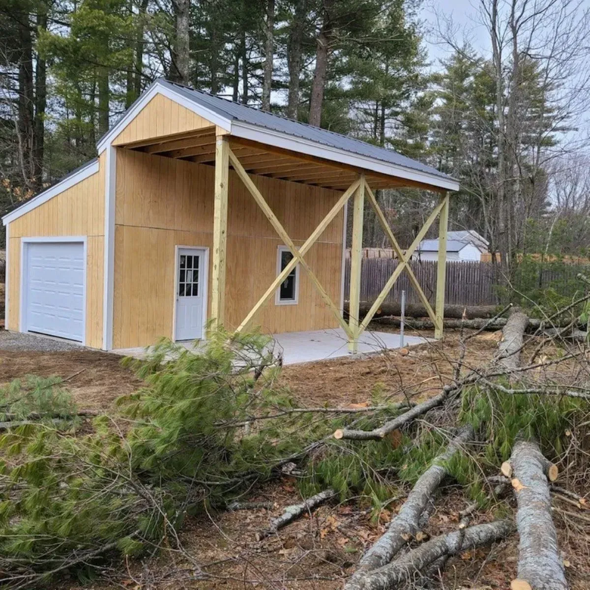 A wooden garage with a porch is being built in the middle of a forest.
