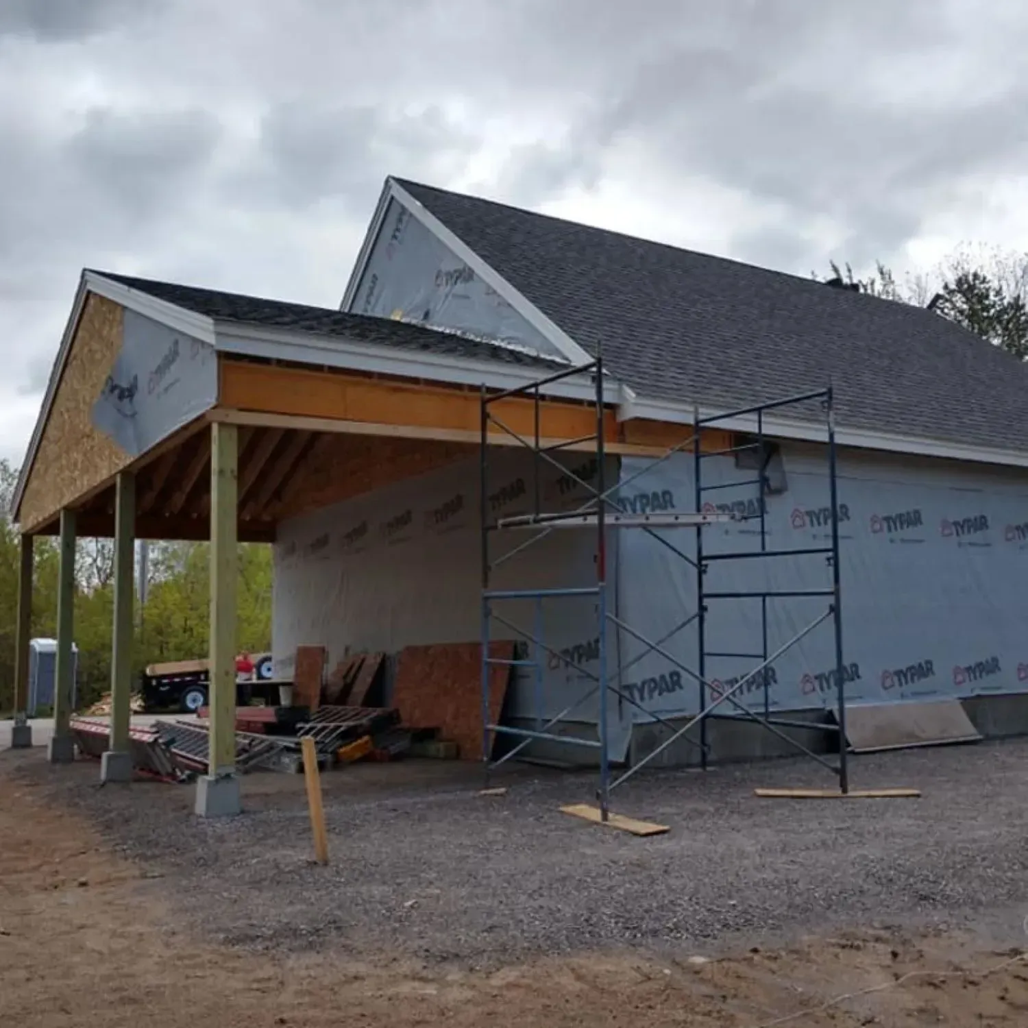 A house under construction with a scaffolding in front of it