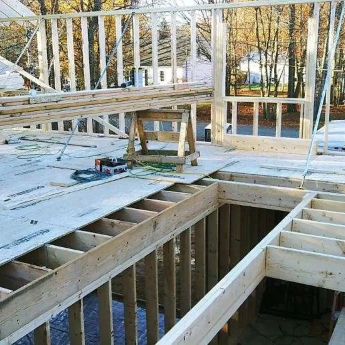 A wooden structure under construction with a stool in the middle