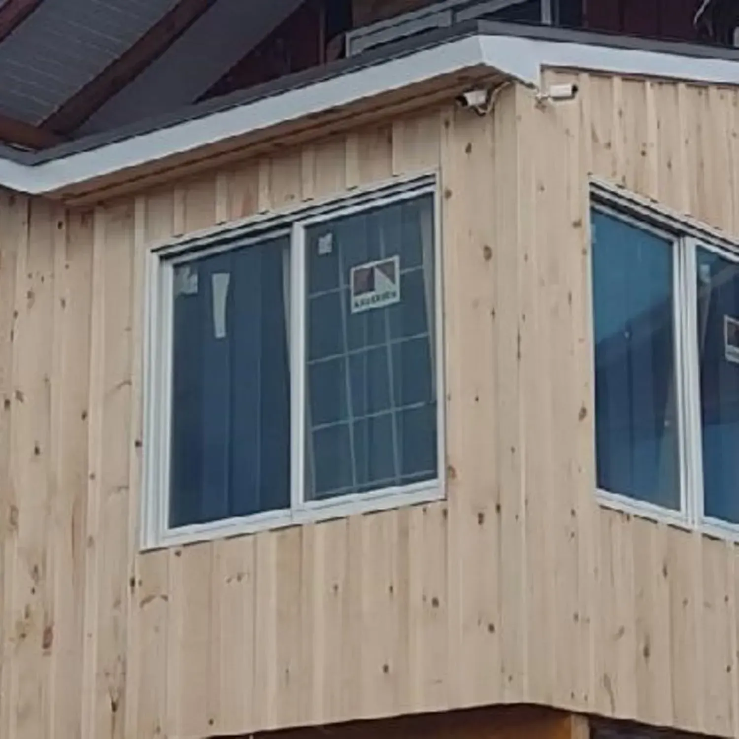 A wooden building with a lot of windows on it