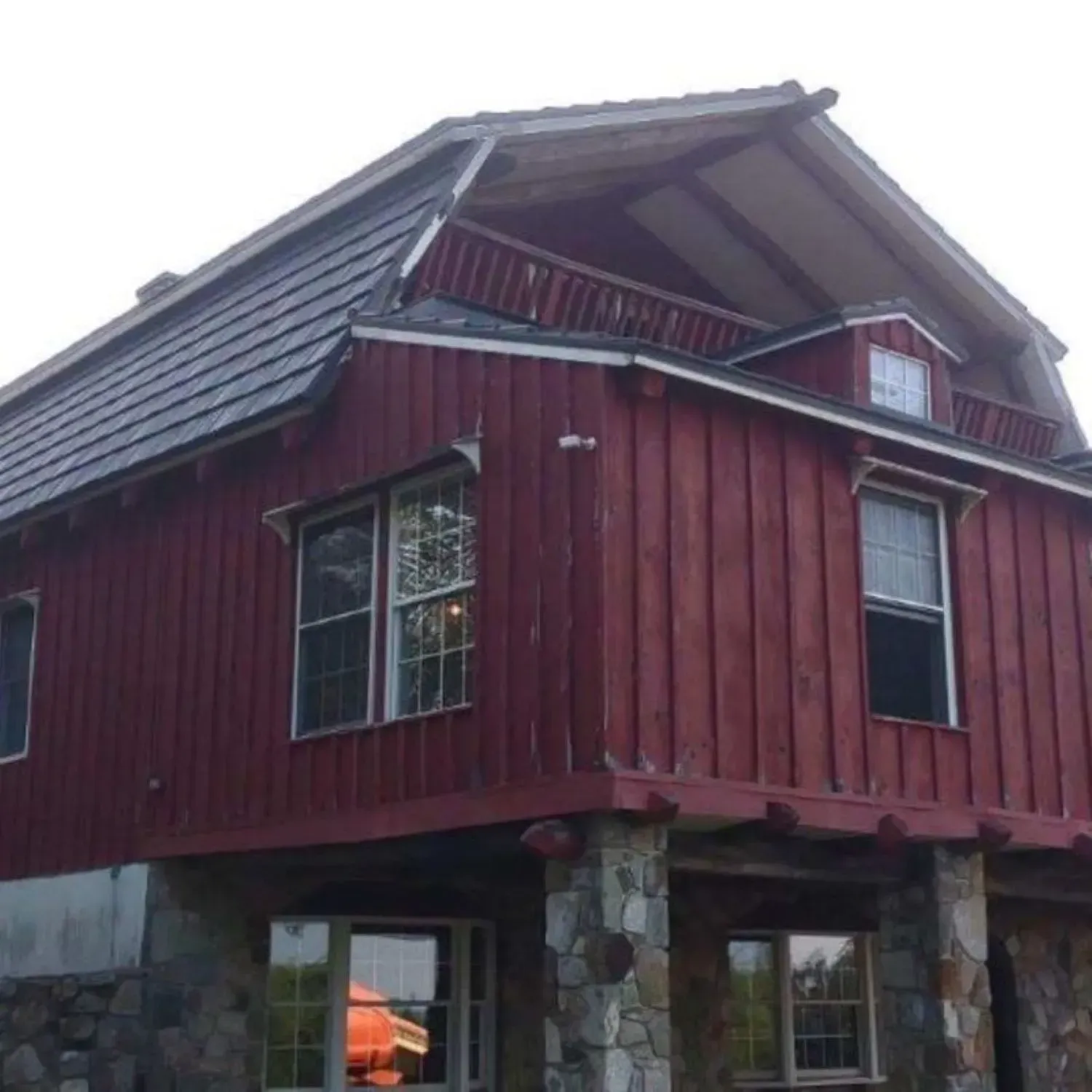 A red house with a balcony on top of it
