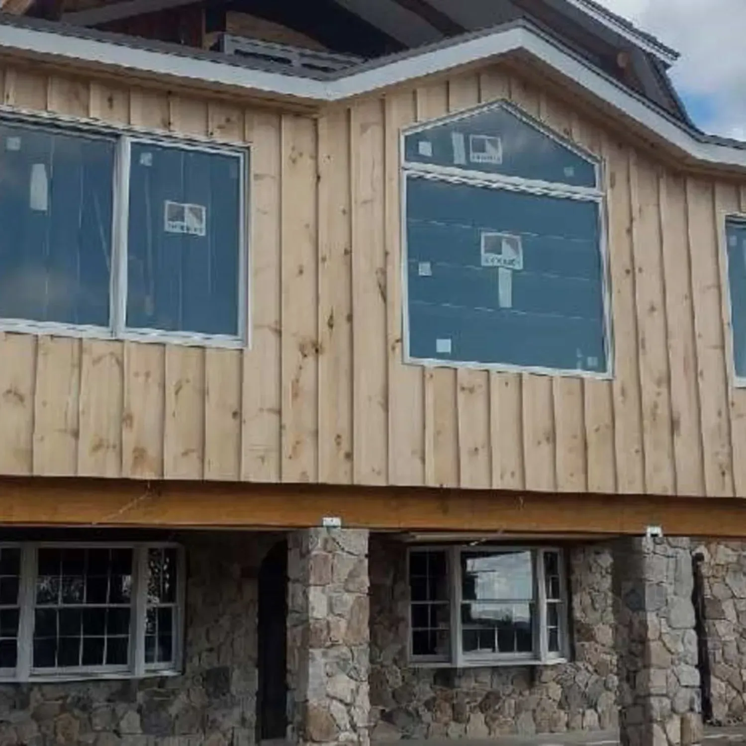 A house that is being built with a lot of windows
