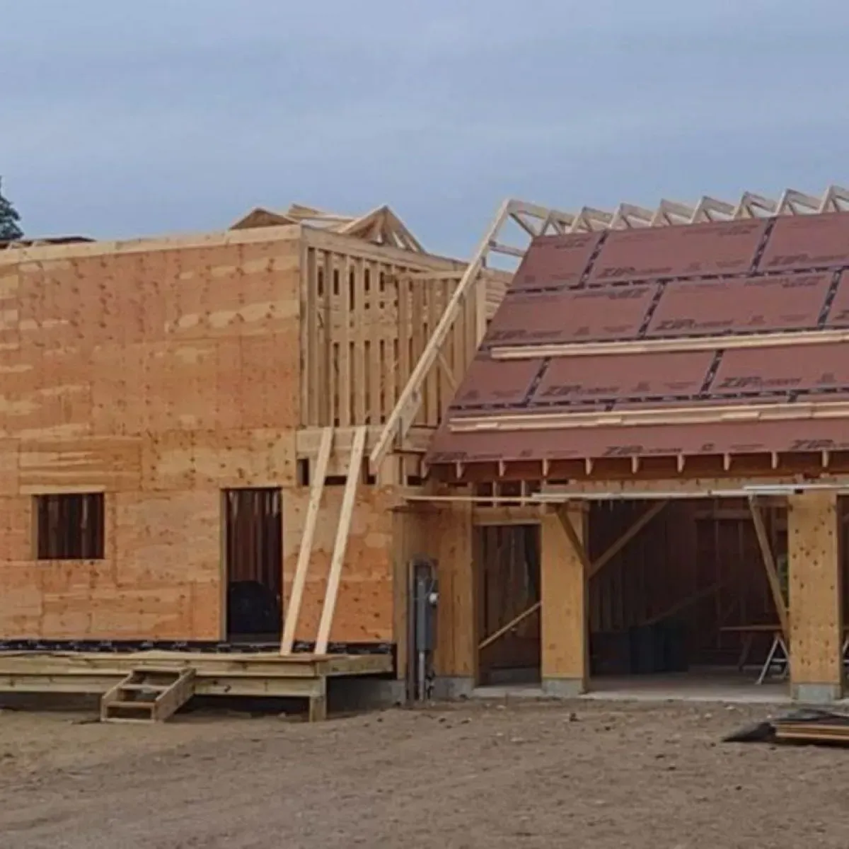 A house that is being built with a red roof