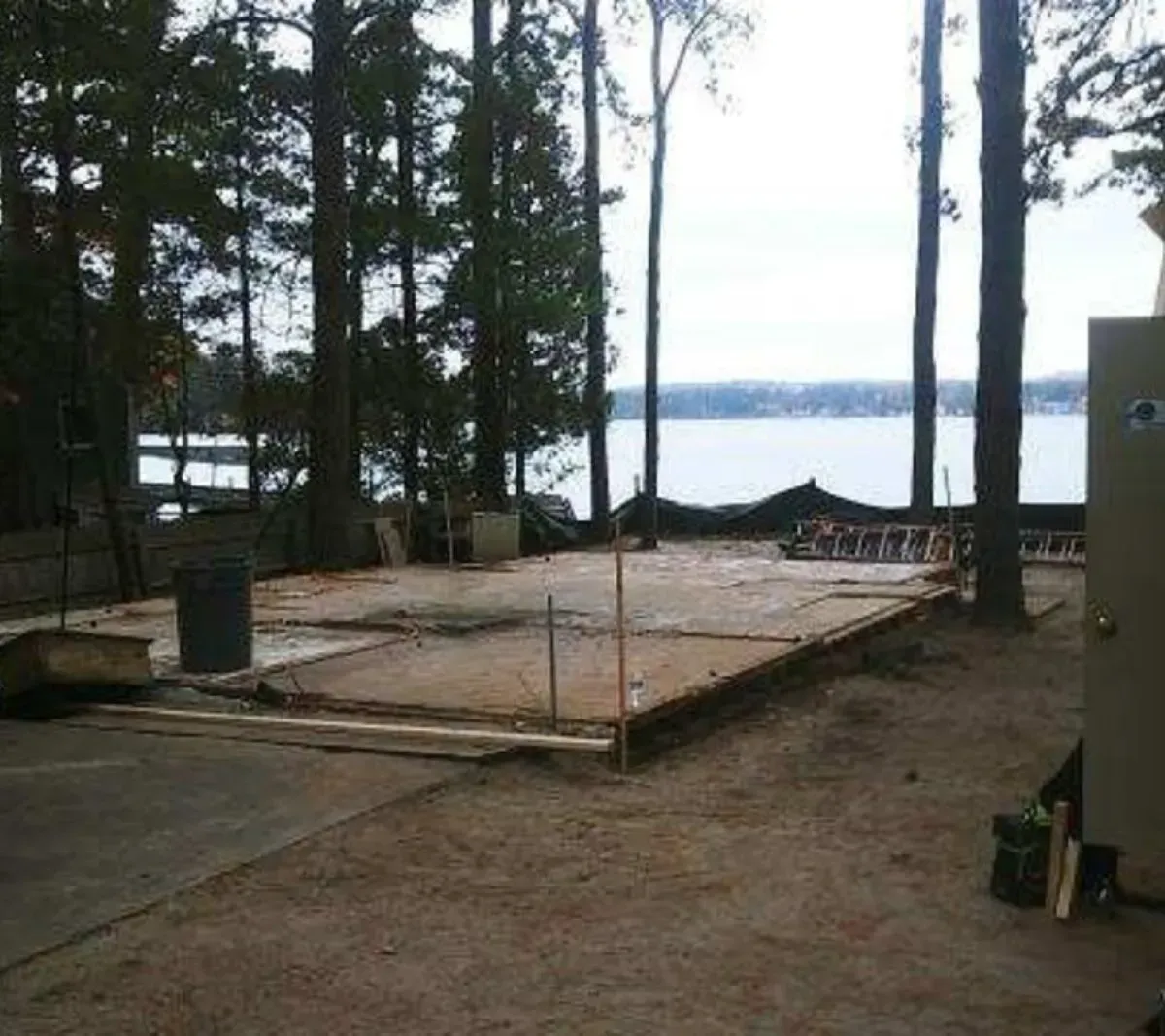 A building under construction with a view of a lake