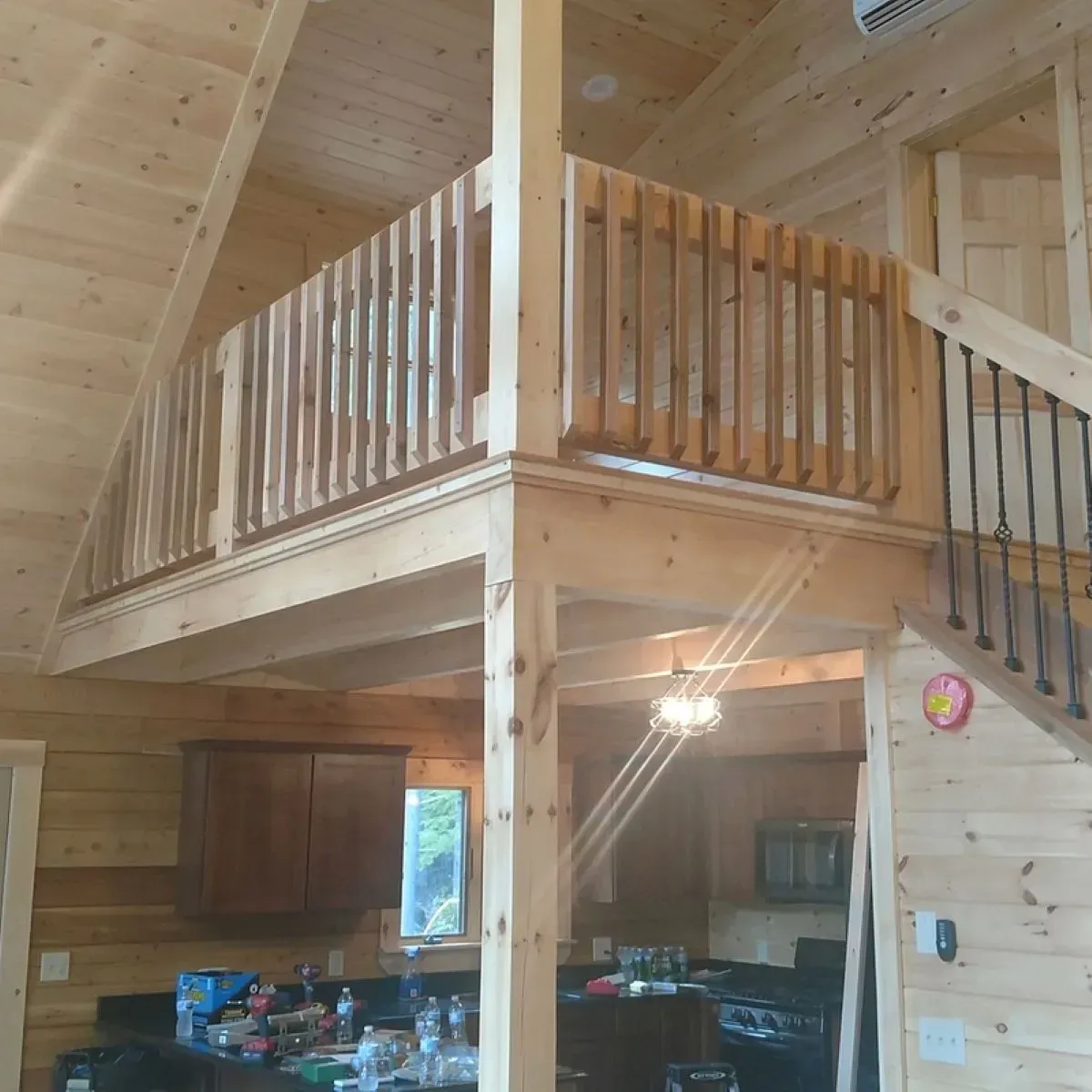 A wooden house with a balcony and stairs