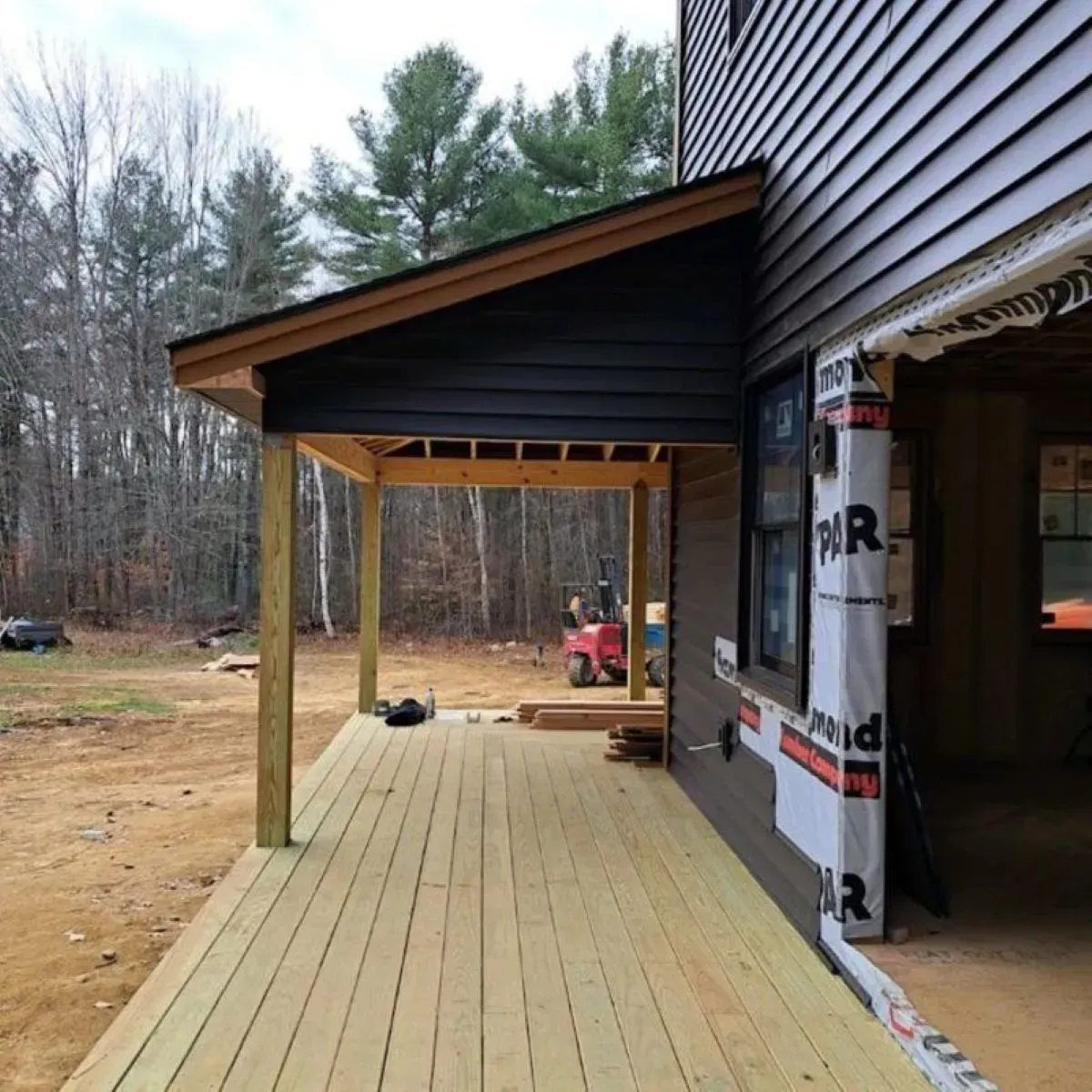 A wooden deck is being built on the side of a house