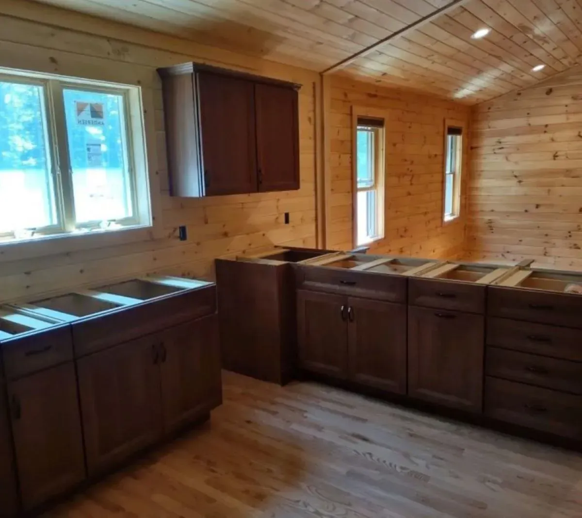 A kitchen with a lot of cabinets and sinks