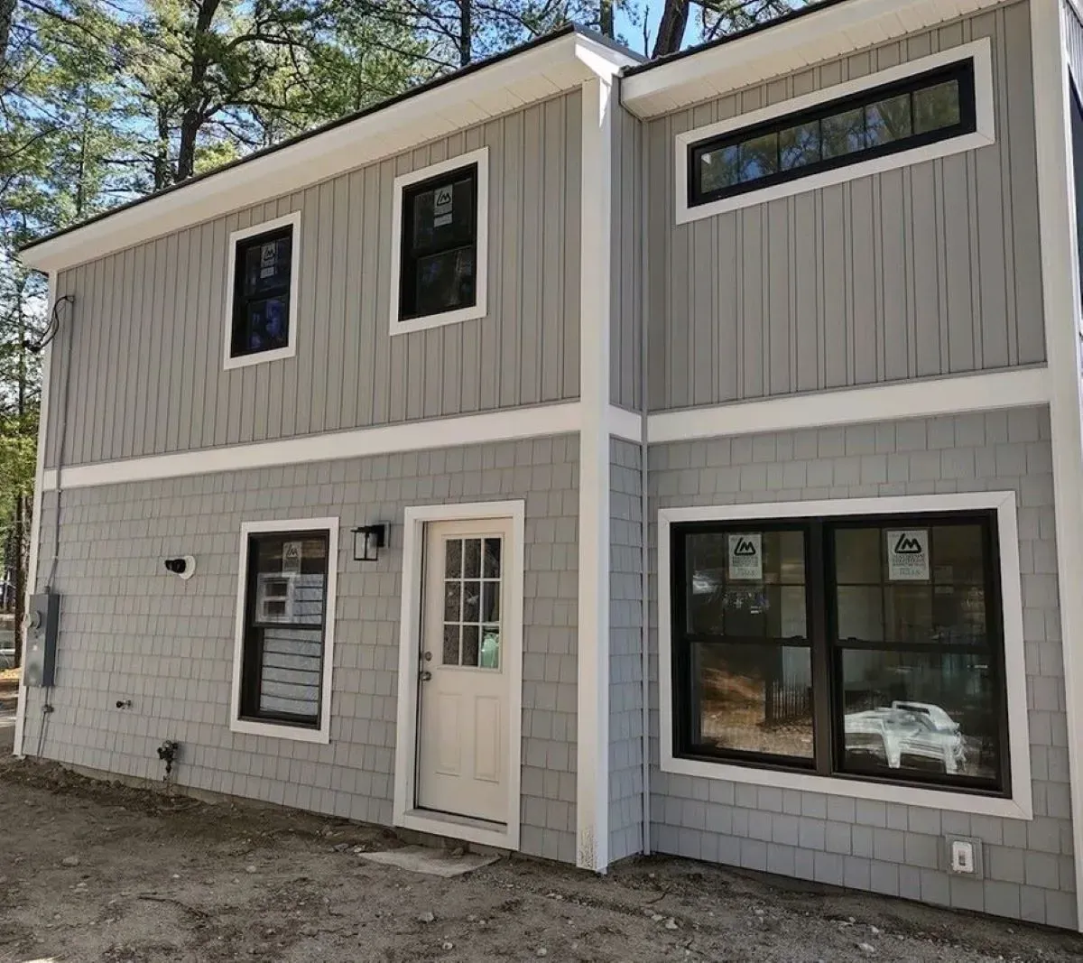 A house with a lot of windows and a door