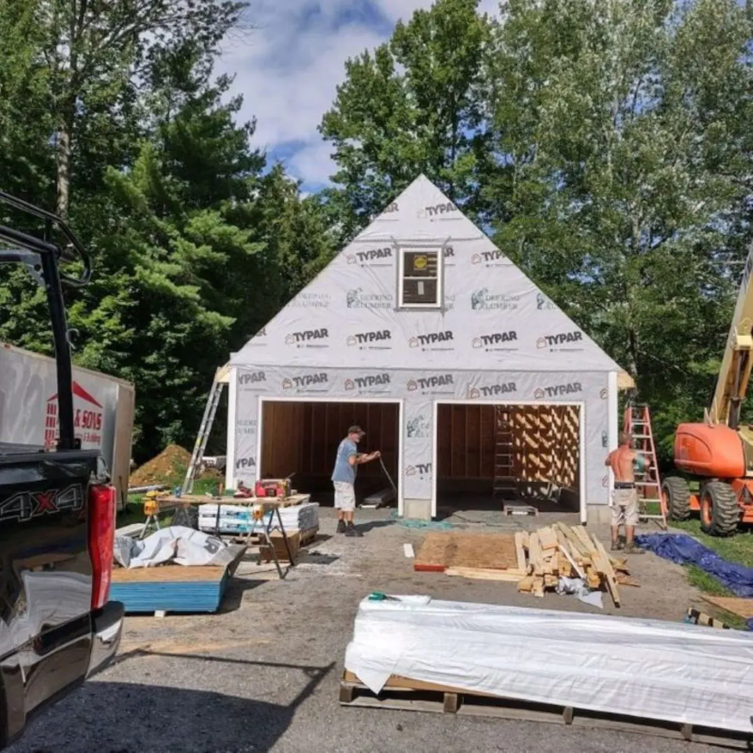 A man is working on a garage that is being built
