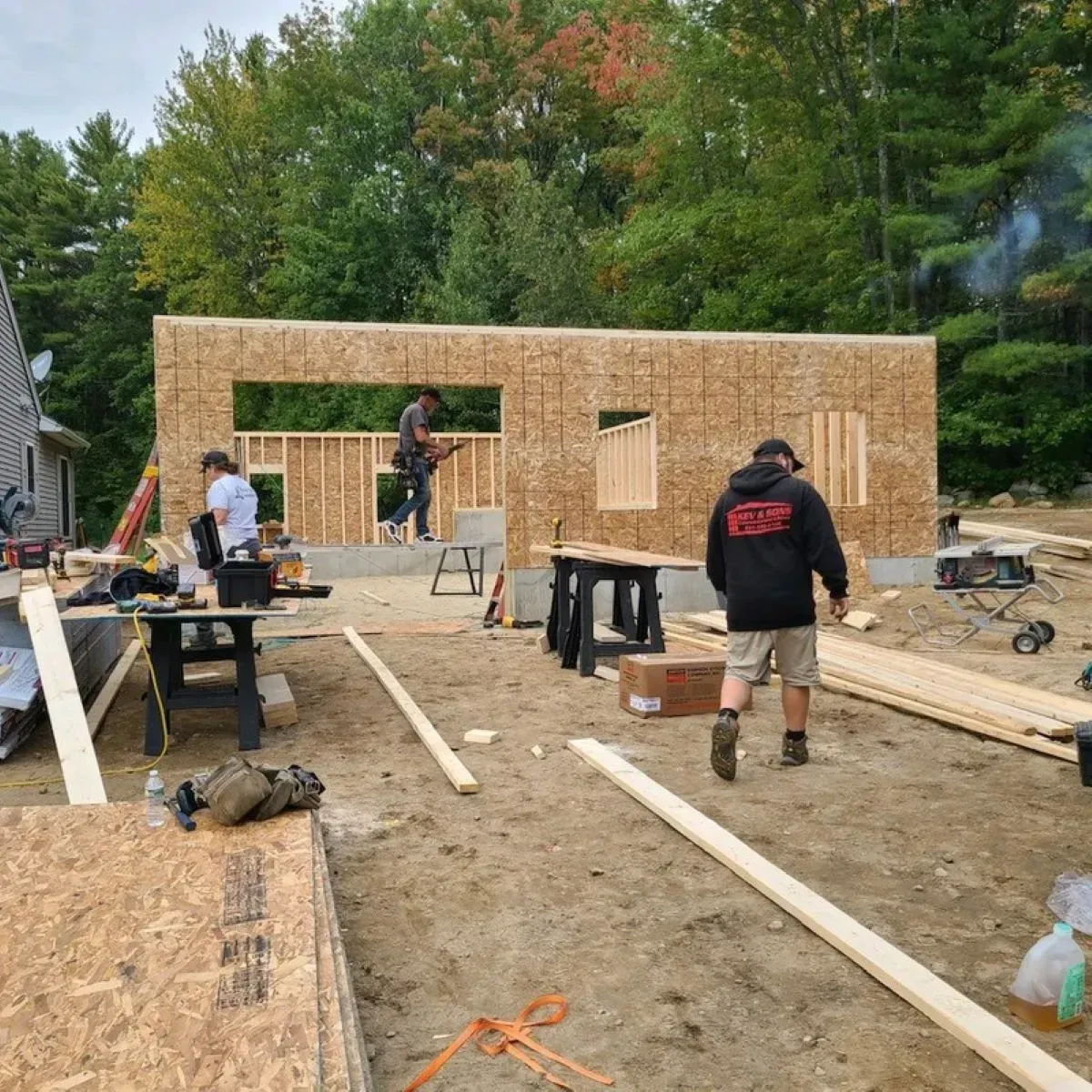 A group of people are working on a house under construction.