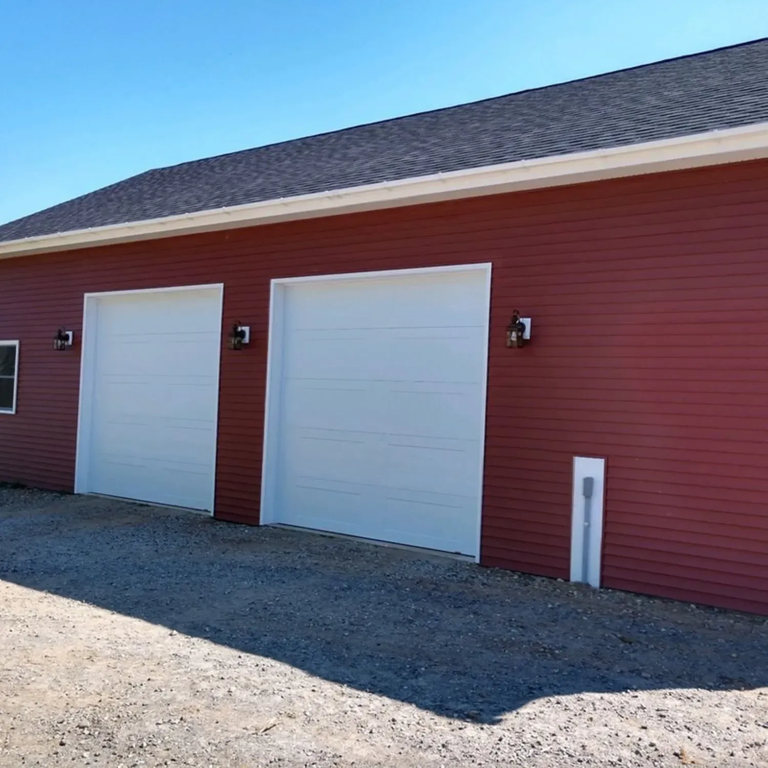A red garage with two white garage doors