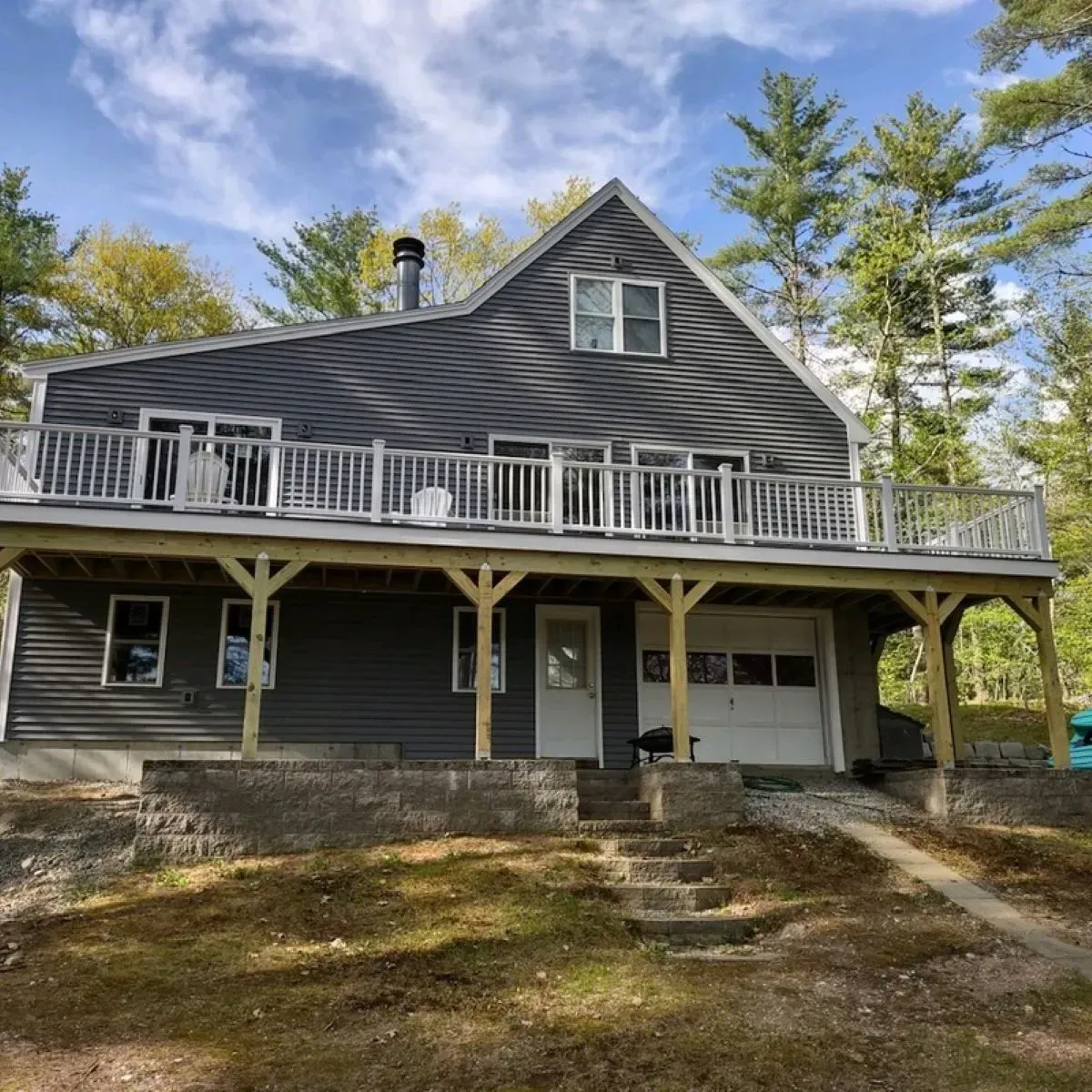 A large house with a large deck and stairs