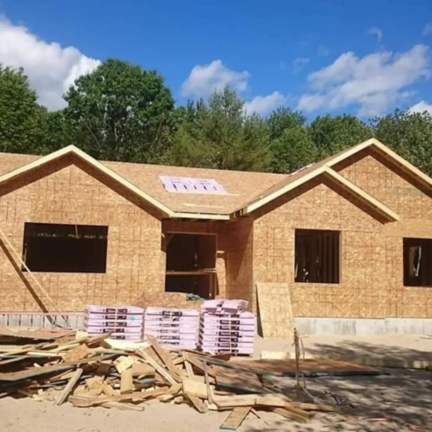 A house that is being built with a blue sky in the background