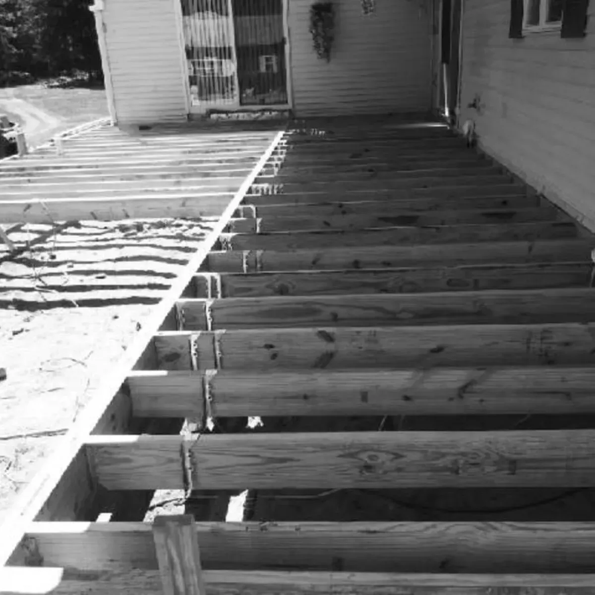 A black and white photo of a wooden deck under construction