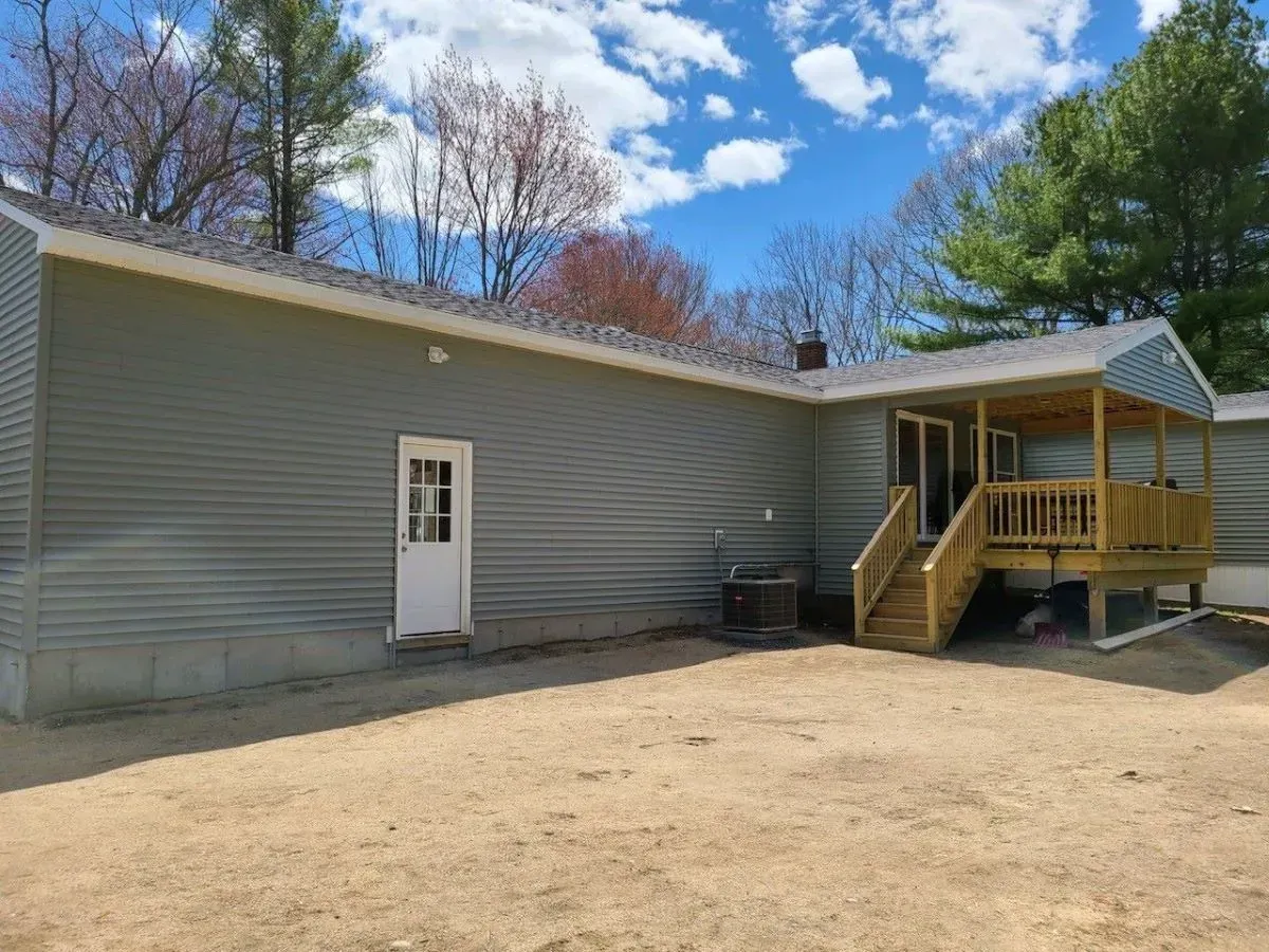The backyard of a house with a porch and stairs