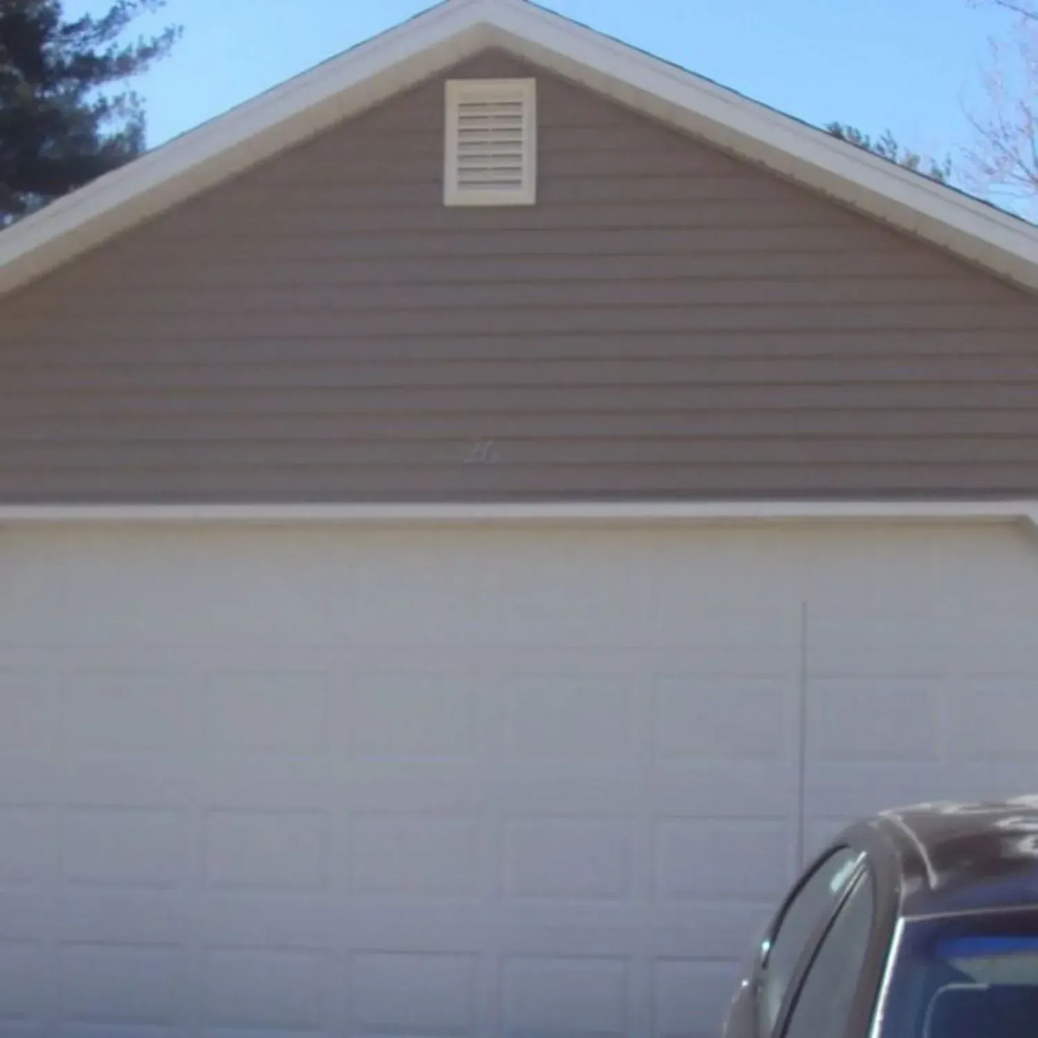 A garage with a car parked in front of it