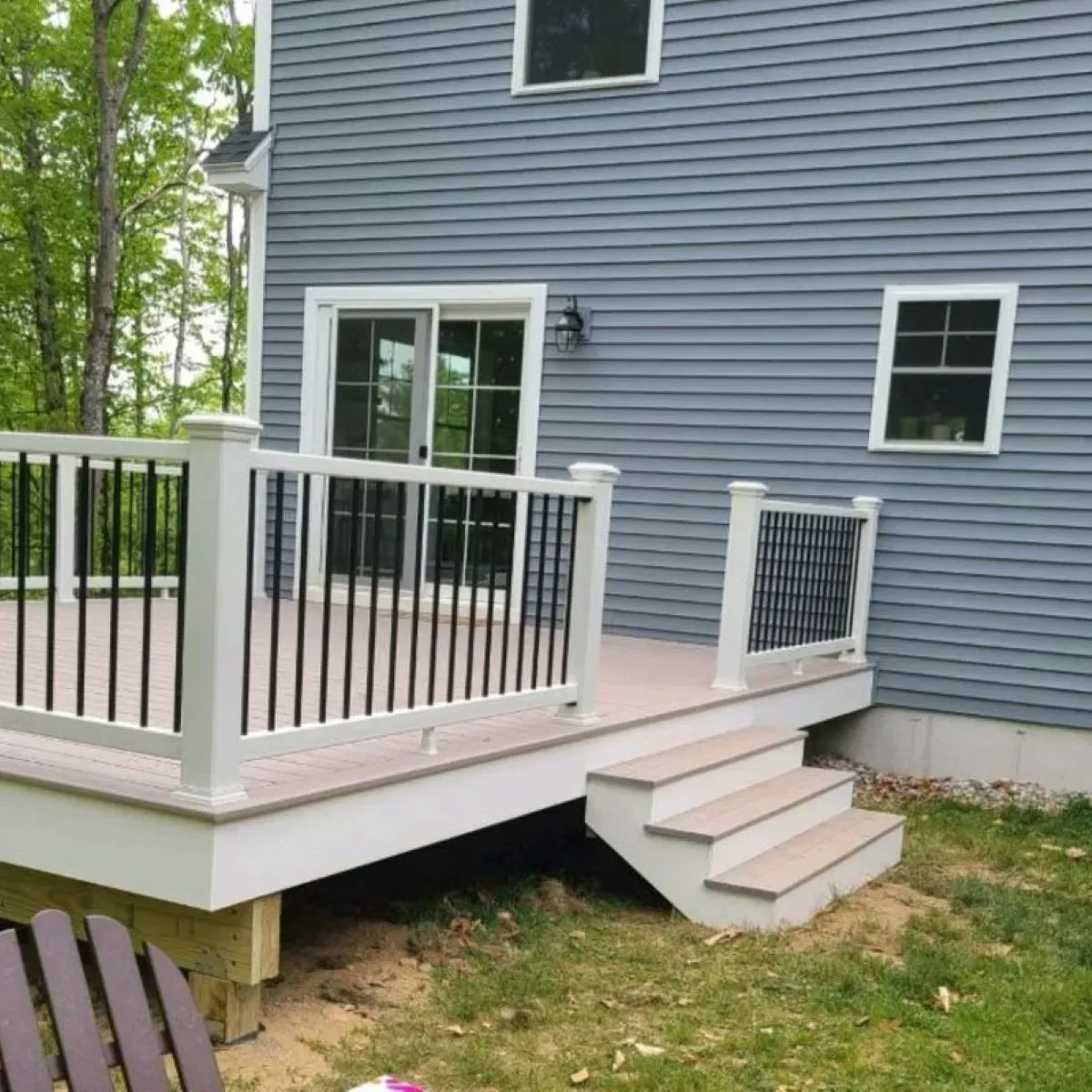 A blue house with a white deck and stairs