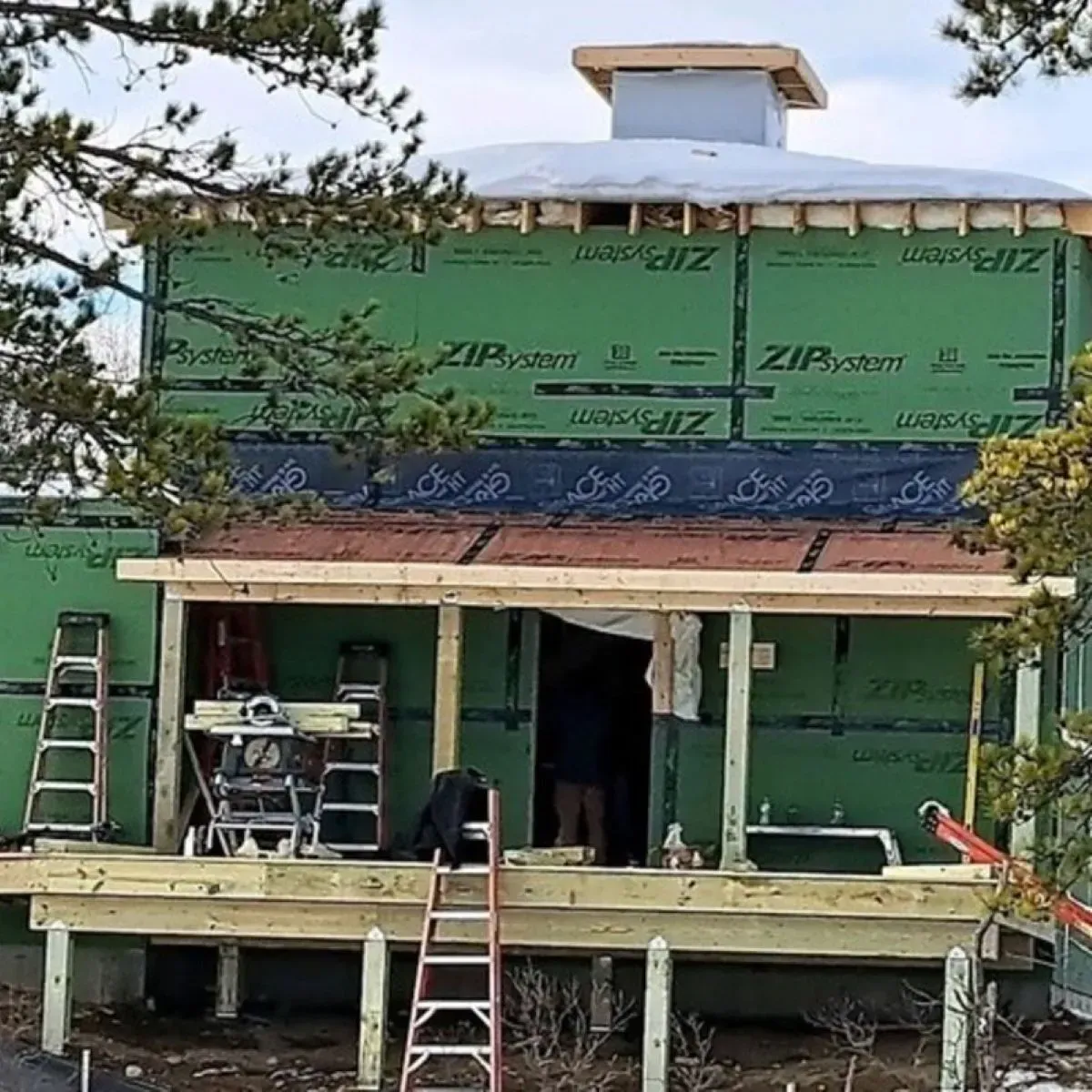A house is being built with a porch and a roof.