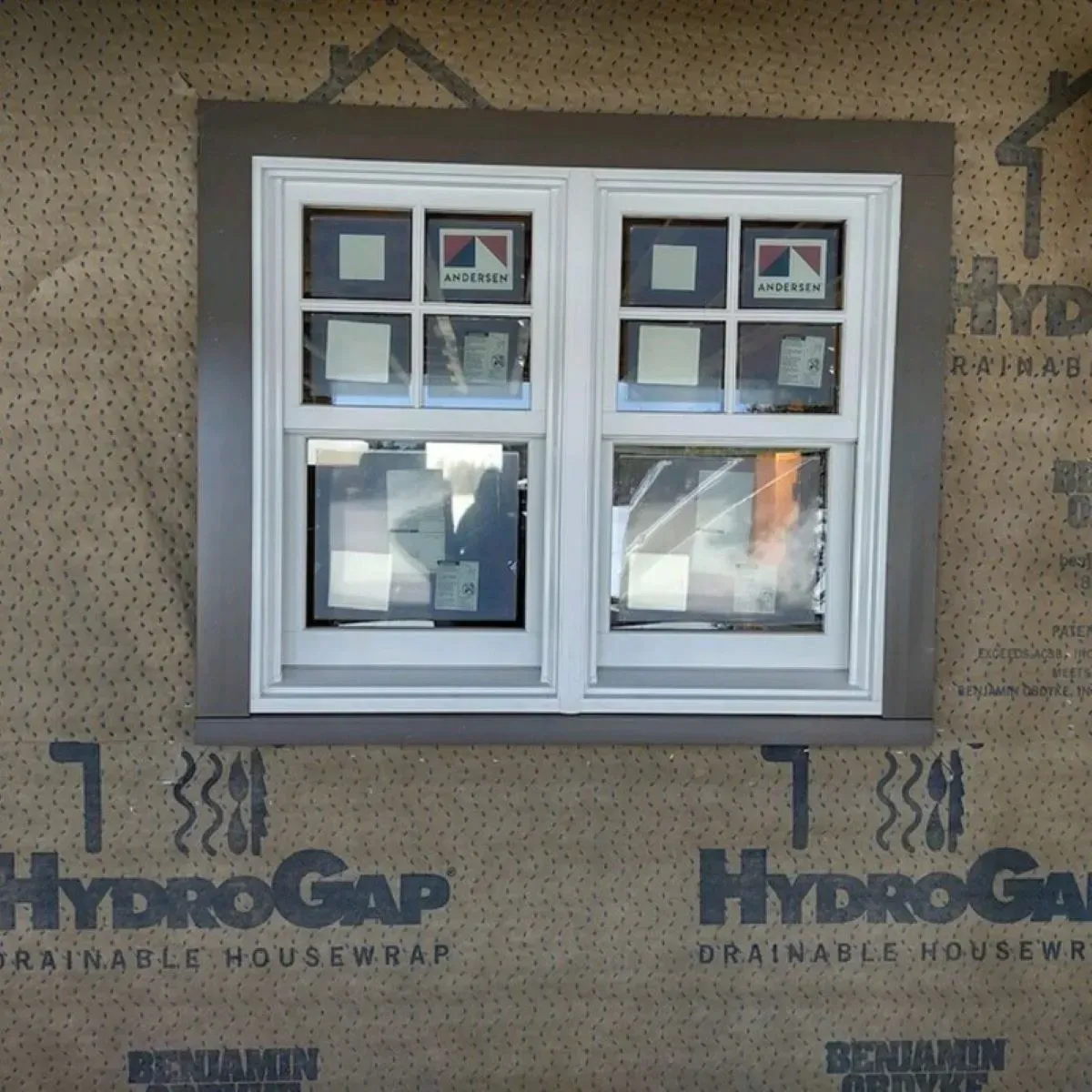 A window is surrounded by hydrogap drainable housewrap
