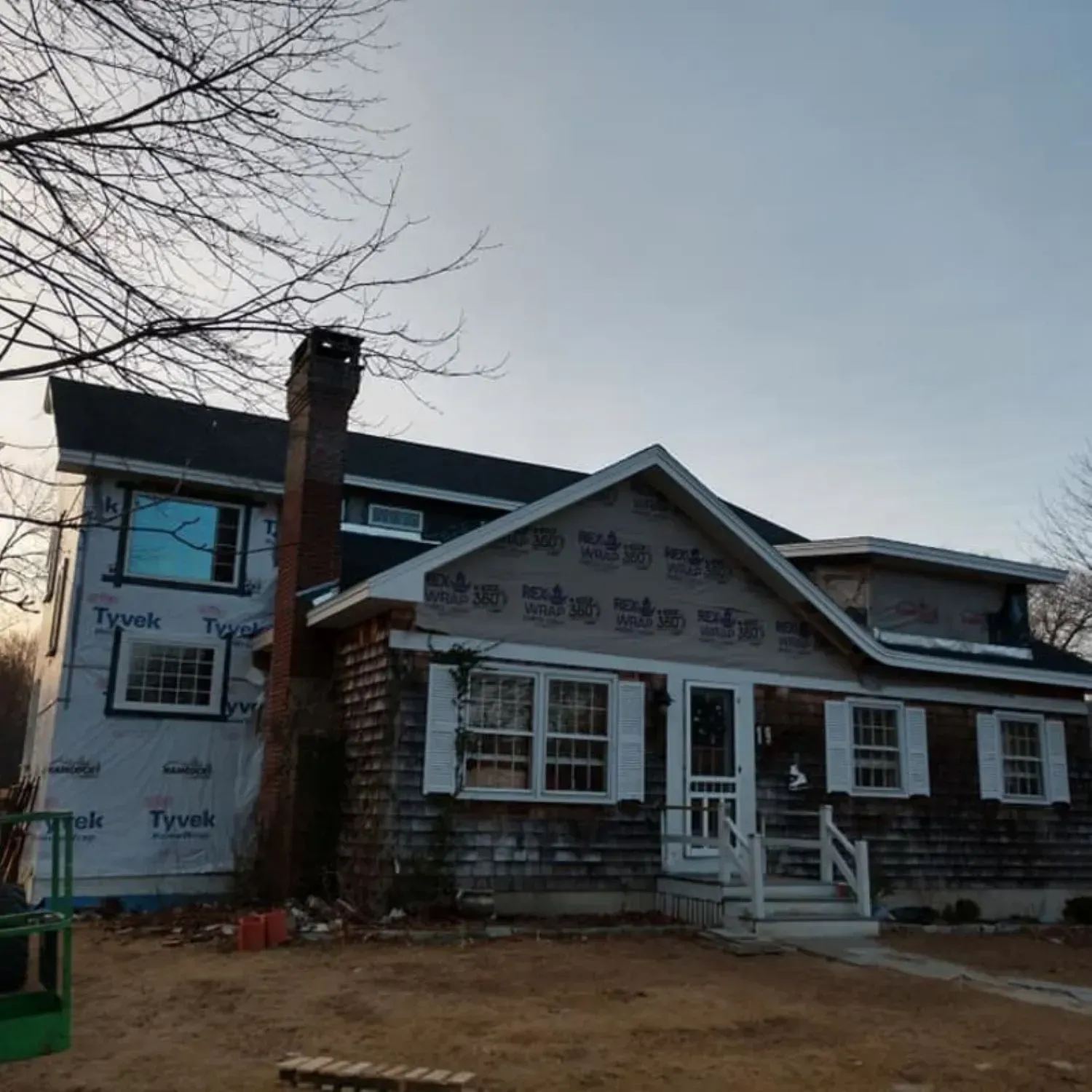A house with a roof that has a chimney on it