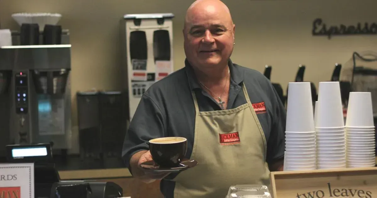 Image of a man holding coffee