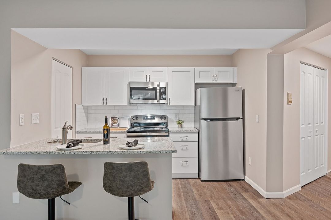 Interior Photo of 860 East Kitchen with White Cabinets and Black Appliances