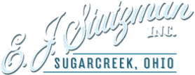 Logo for E. J. Stutzman Inc. Sugarcreek, Ohio in cursive script with a blue underline.