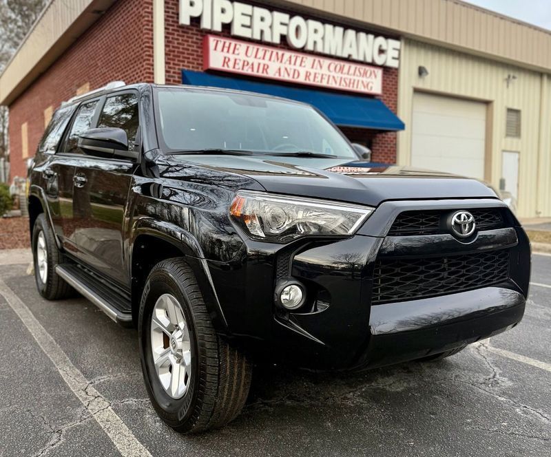 A black Toyota 4Runner parked in front of a building with a 