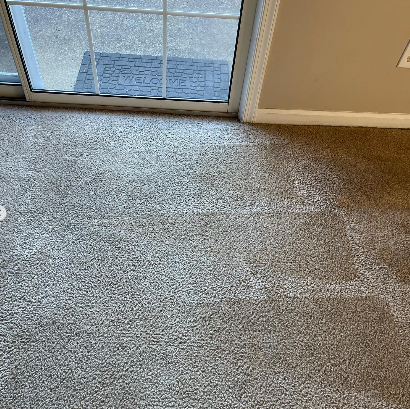 a carpeted floor in a room next to a sliding glass door .
