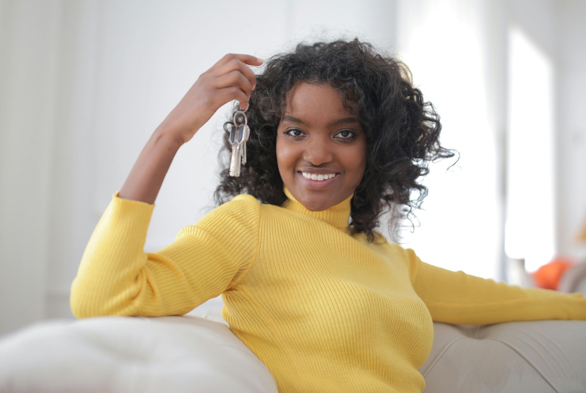 woman holding house keys smiling