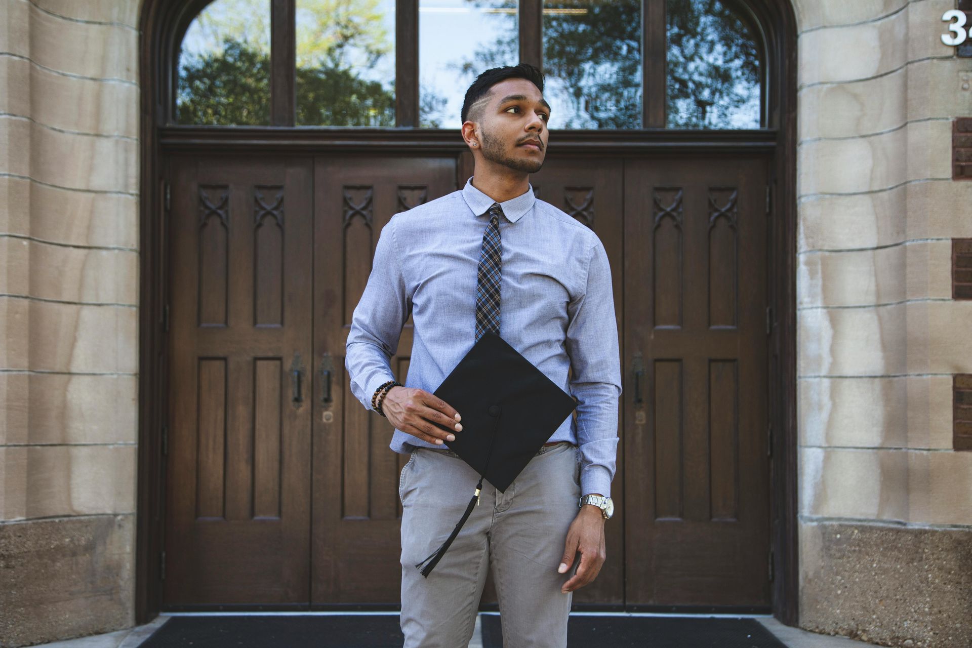 College graduate looking at a house