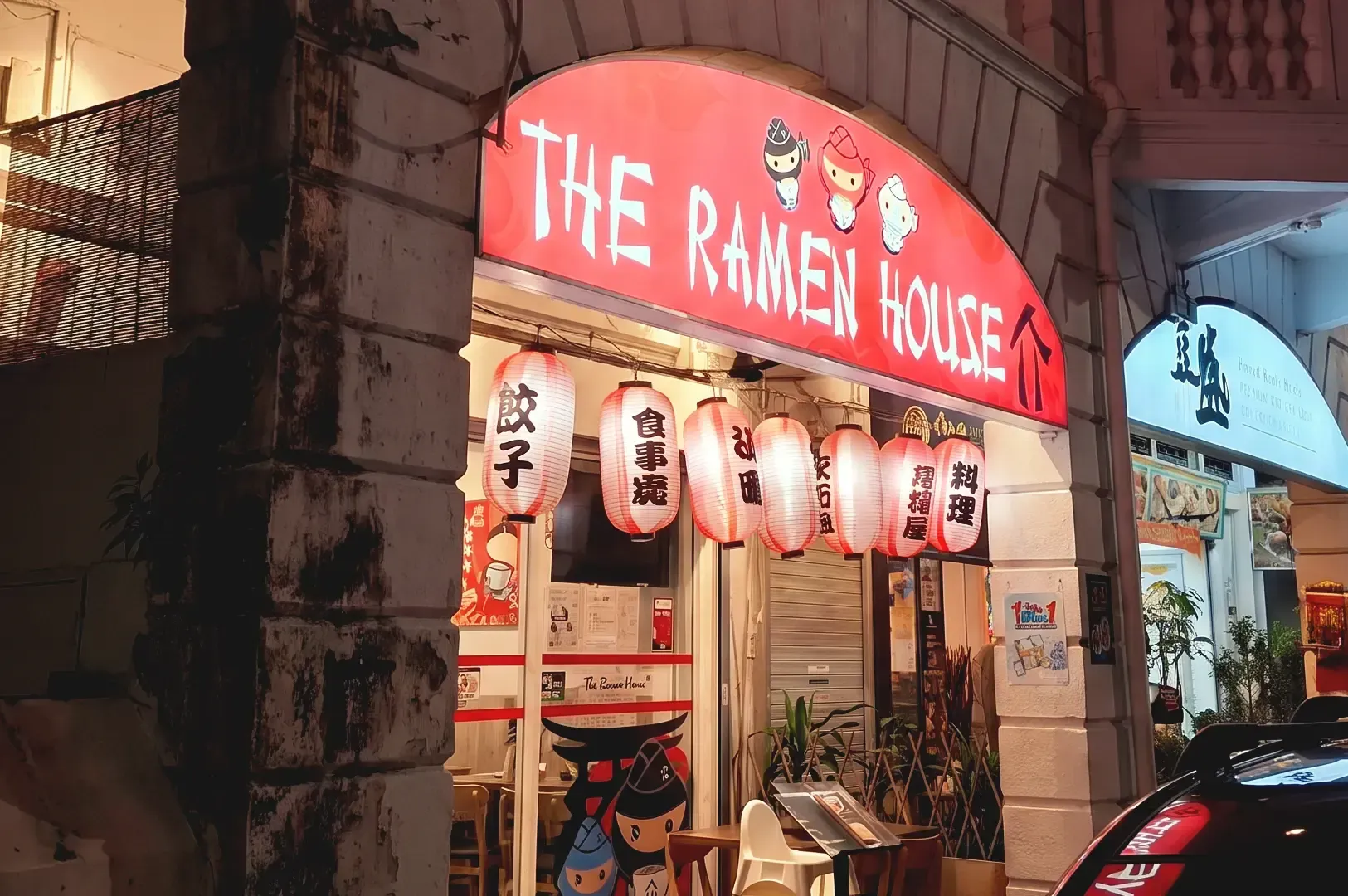 Stone structure bulding and red lit signage of The Ramen House in Singapore