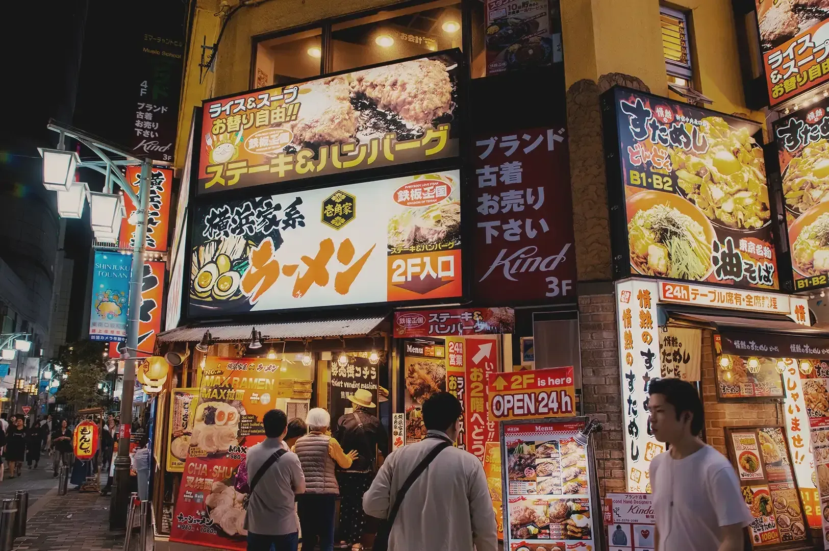 A ramen shop building installed with numerous ramen promotional LED boards and menu posters