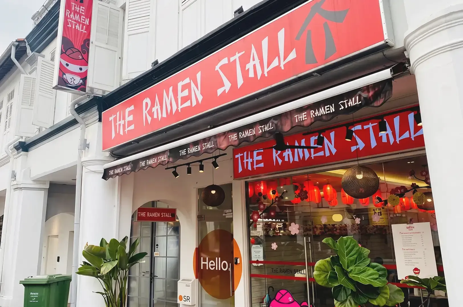 Ramen Stall storefront with red signages and peek of interior decorated with japanese red lanterns