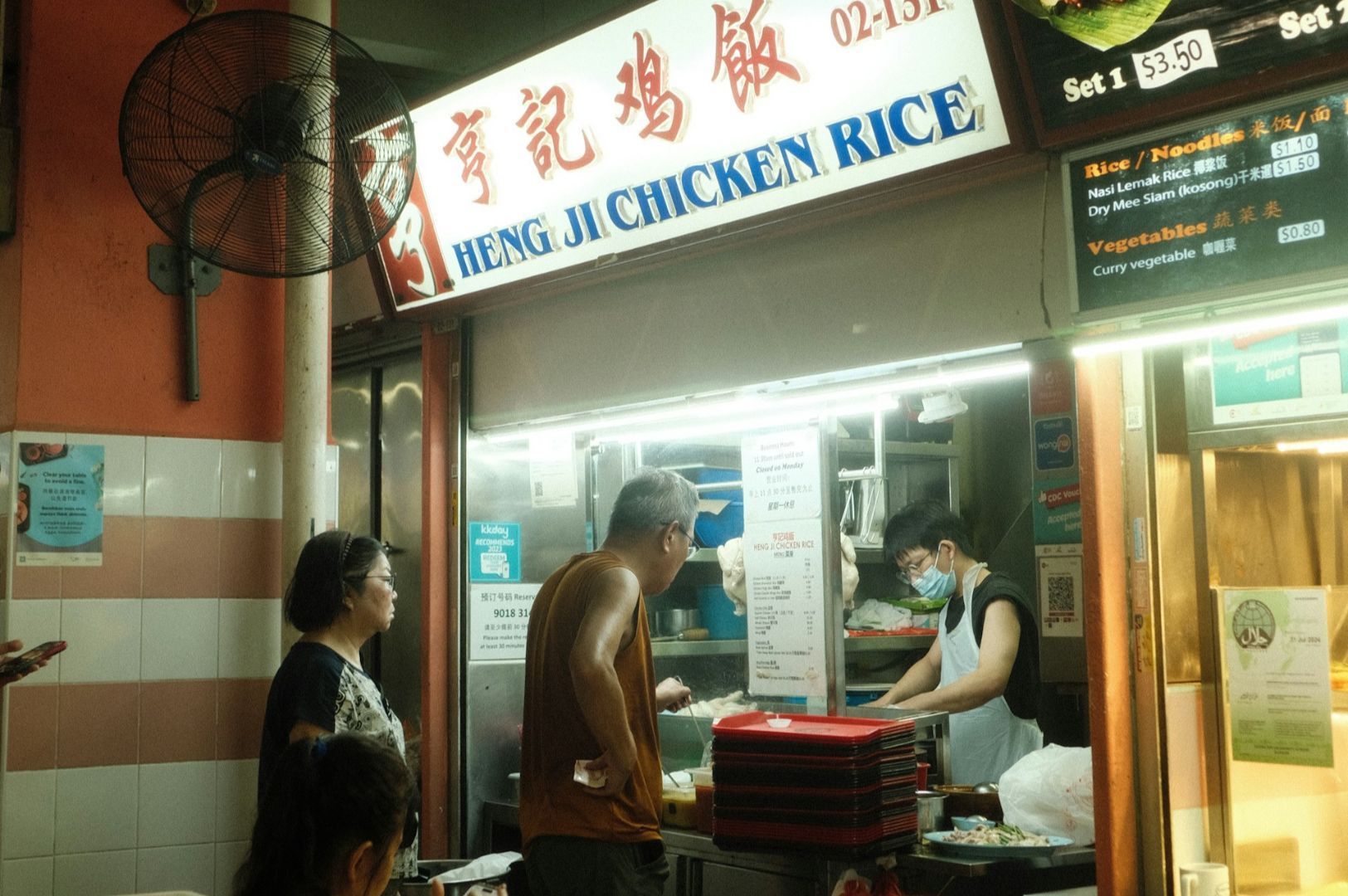 A man orders food at a hawker stall named