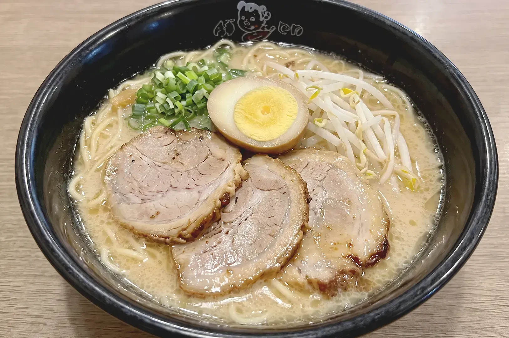 Classic Ajisen ramen served on black bowl