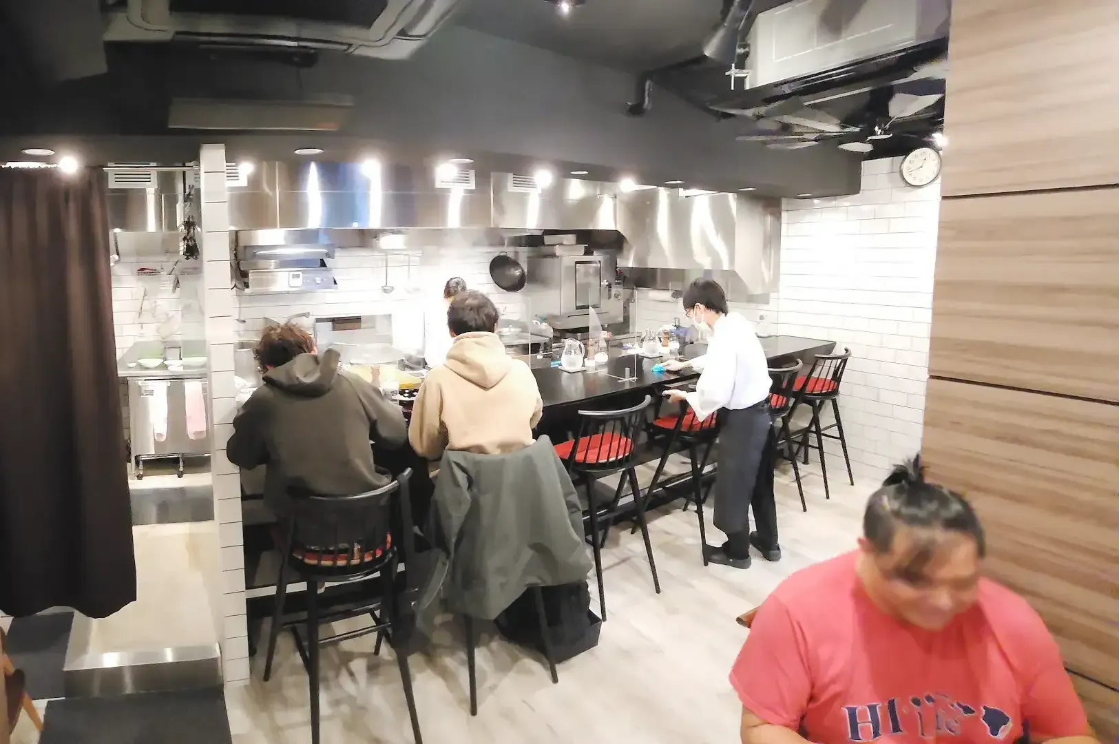 Simple interior of Nakiryu ramen with visible view of kitchen area