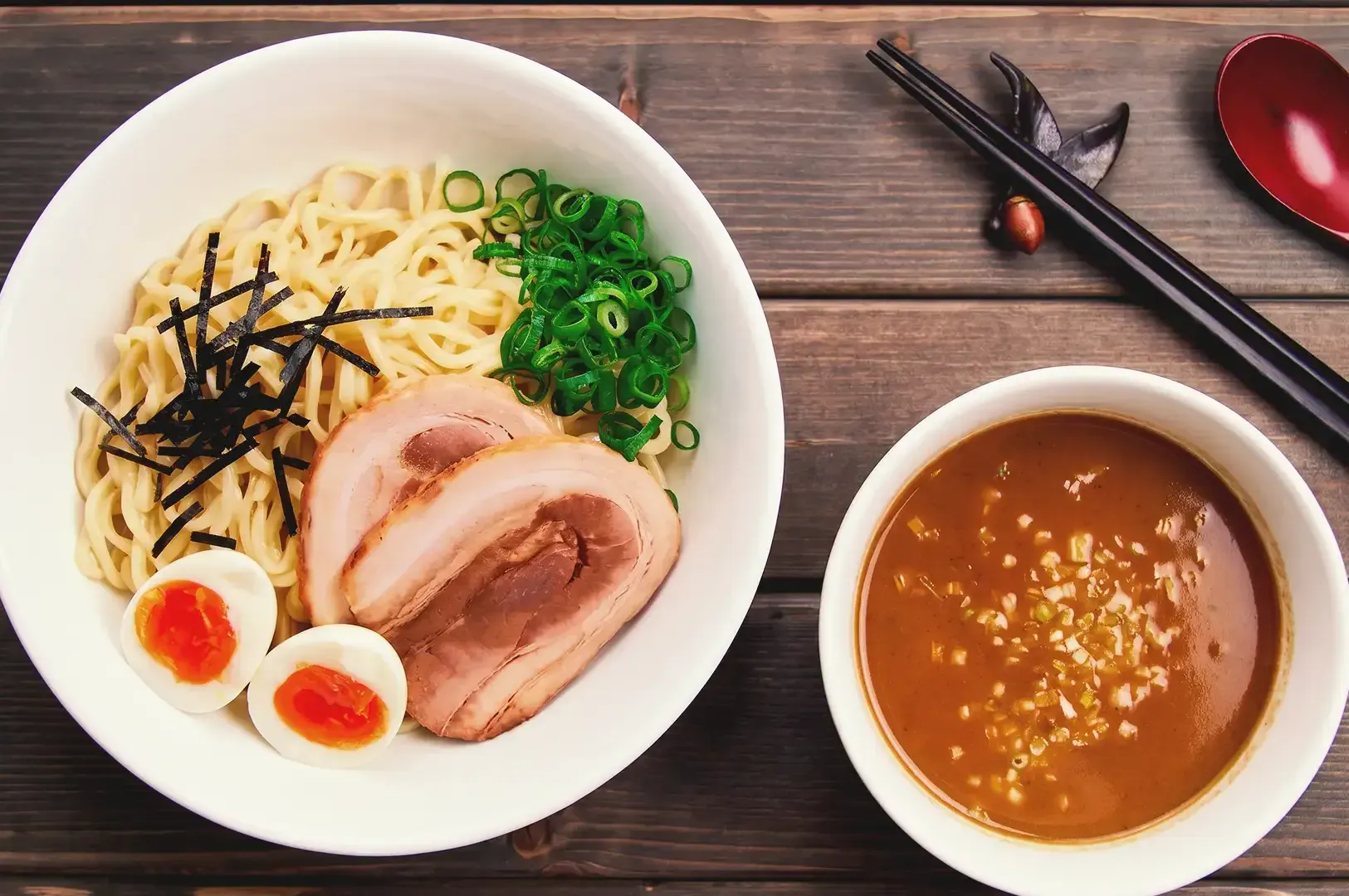 Top view of ramen noodles with spring onions, egg and pork meat separated from the broth