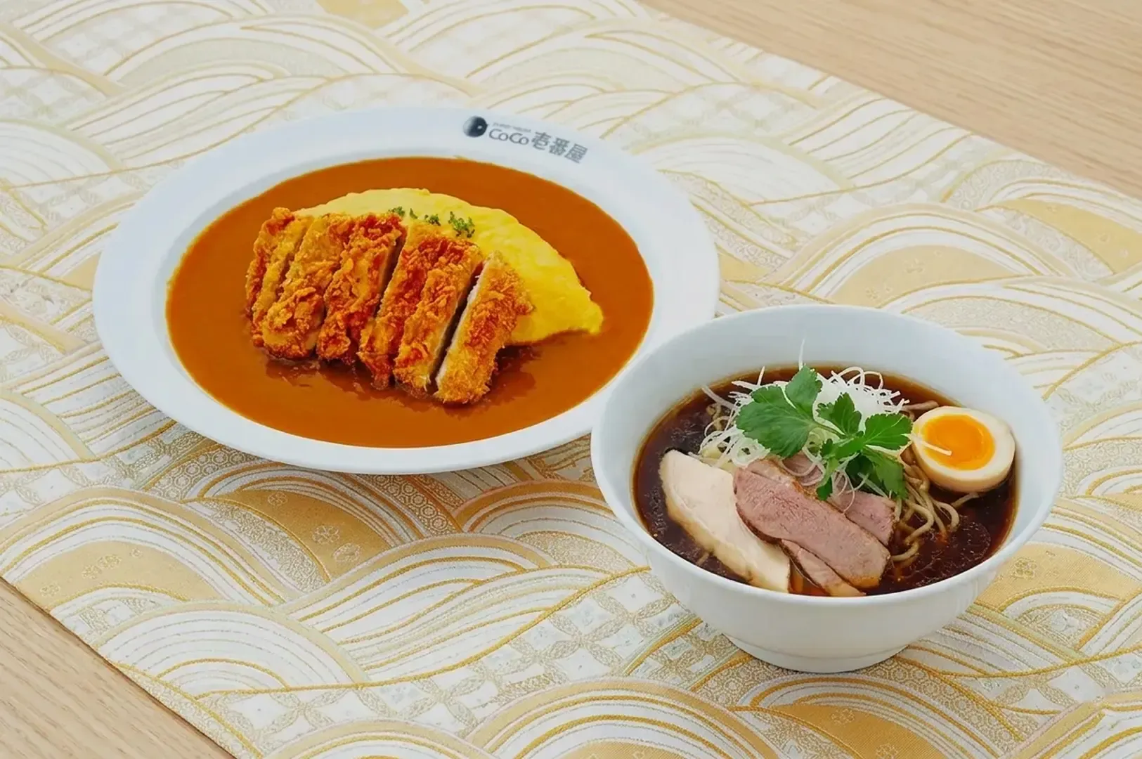 CoCo Ichibanya meal set featuring tonkatsu curry omurice and a side bowl of dark broth ramen with pork slices