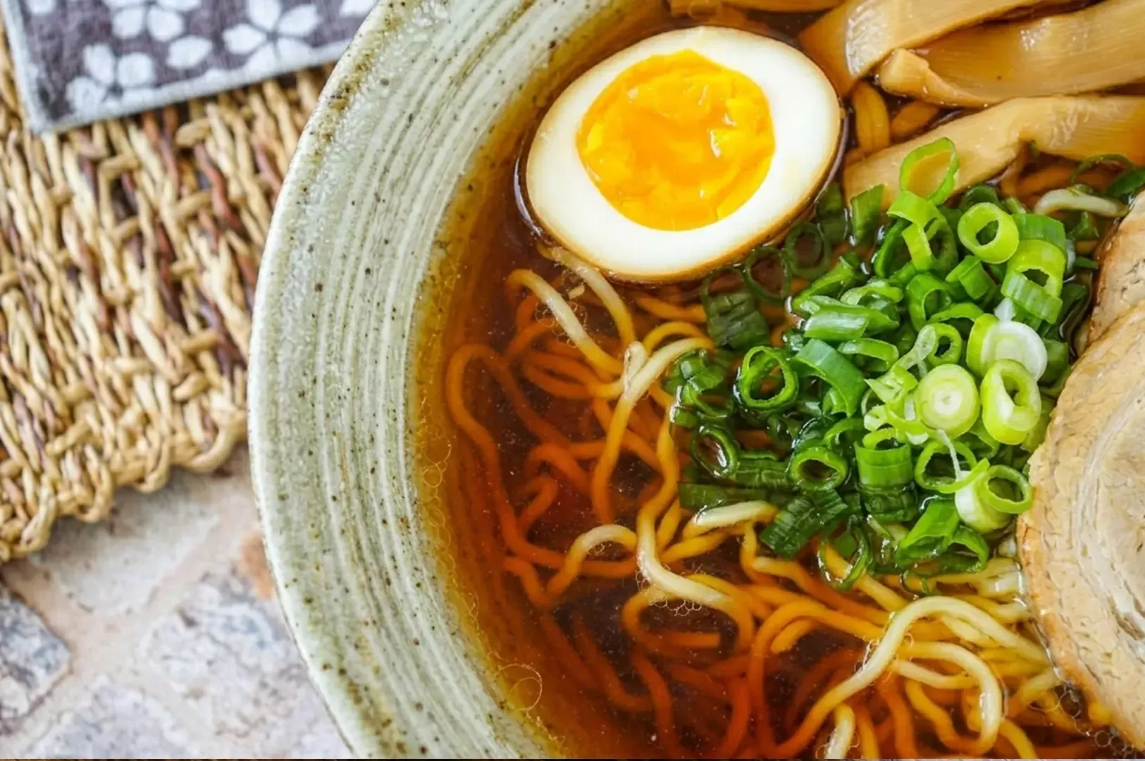 Tokyo-style shoyu ramen with marinated egg, green onions, menma bamboo shoots, and chashu in amber broth