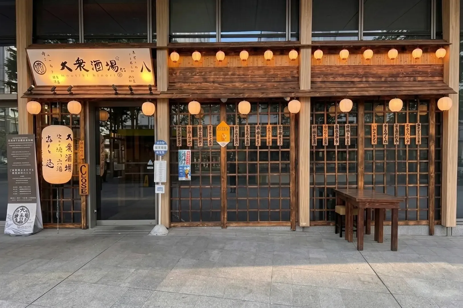 The Public Izakaya by Hachi storefront featuring traditional wooden facade with paper lanterns, lattice windows, and Japanese signage
