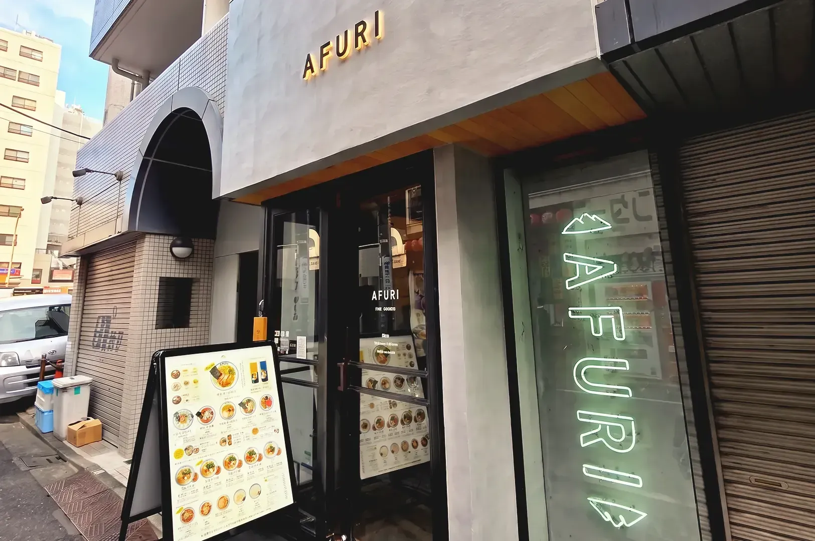 Modern gray storefront of Afuri with menu display and LED light signages